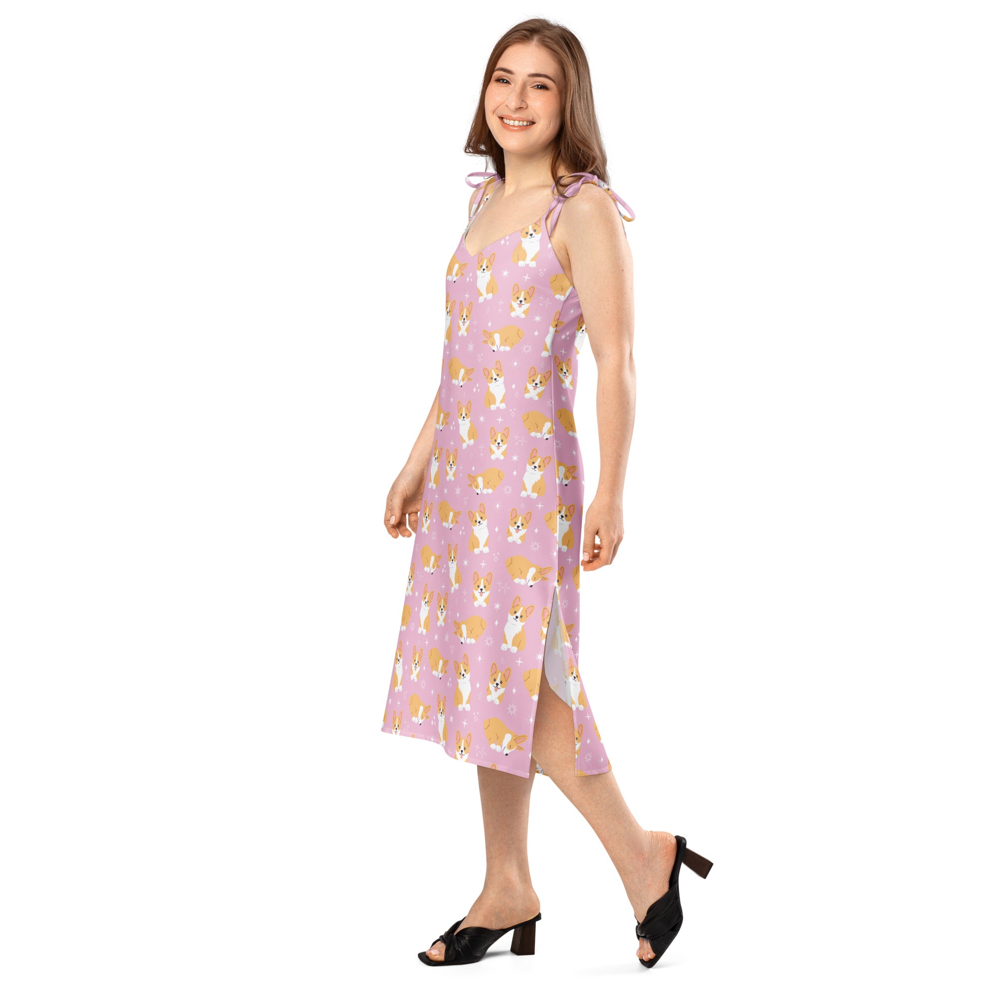 Woman wearing a pink dress with dog pattern on a white background