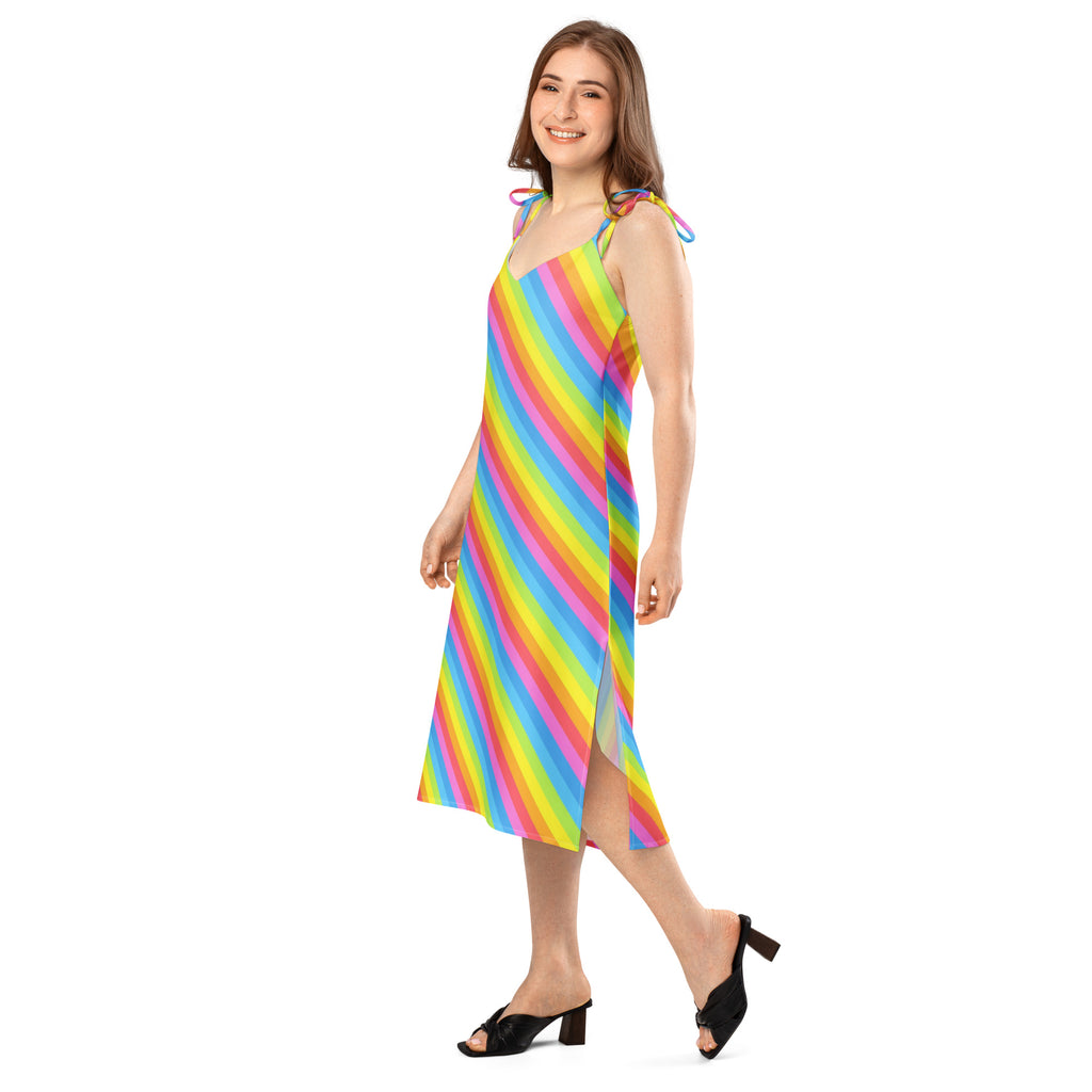 A vibrant rainbow stripe midi slip dress with adjustable tie straps and a side slit featuring a built in bra