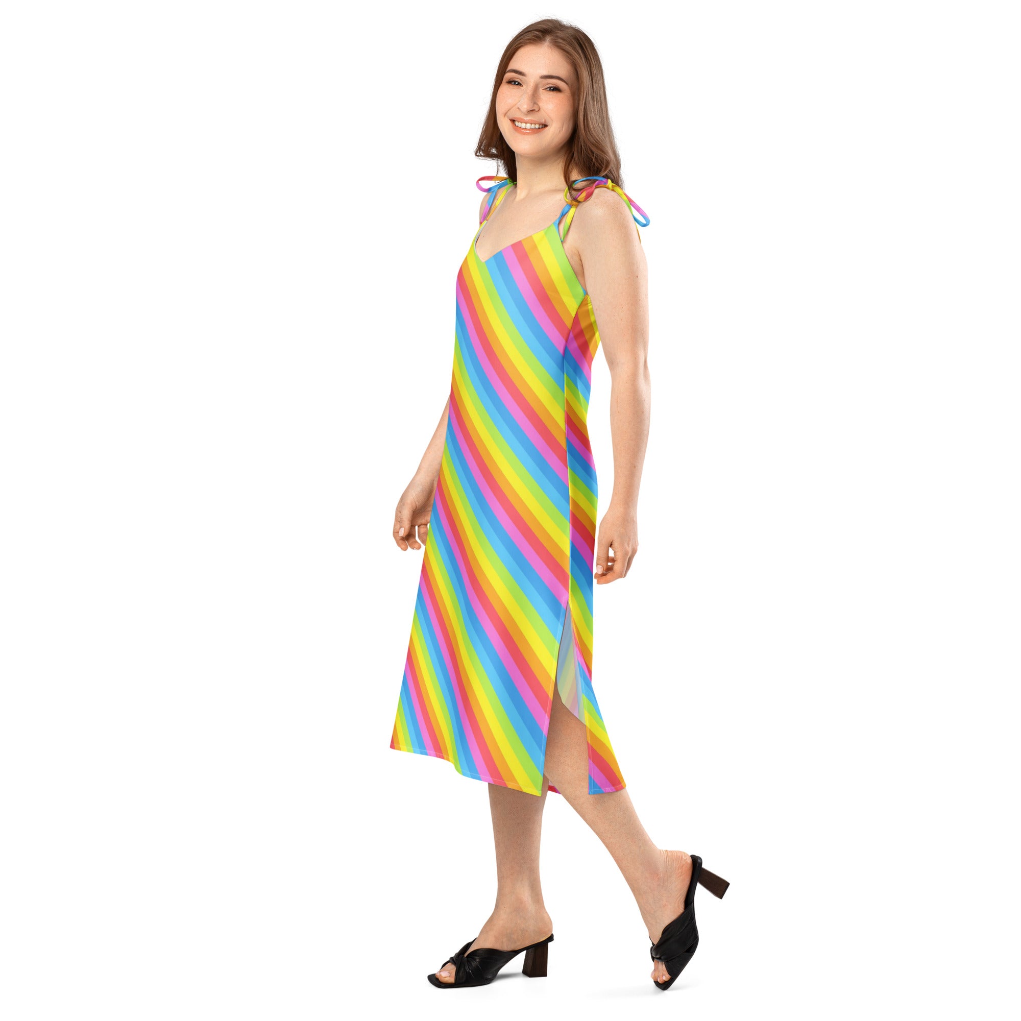 A vibrant rainbow stripe midi slip dress with adjustable tie straps and a side slit featuring a built in bra