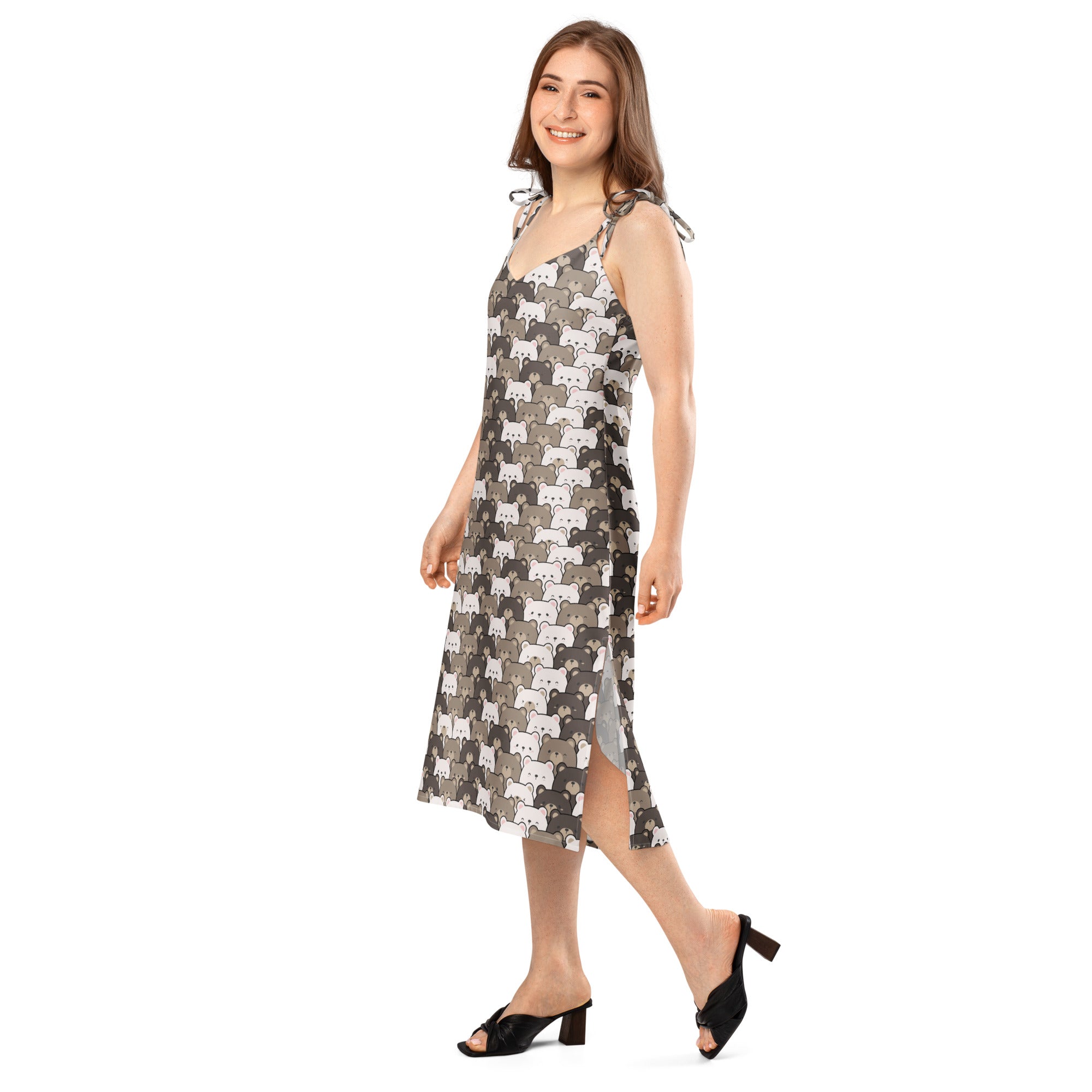 A woman wears a sleeveless midi slip dress with adjustable tie straps and built in bra featuring gray stylized cat patterns