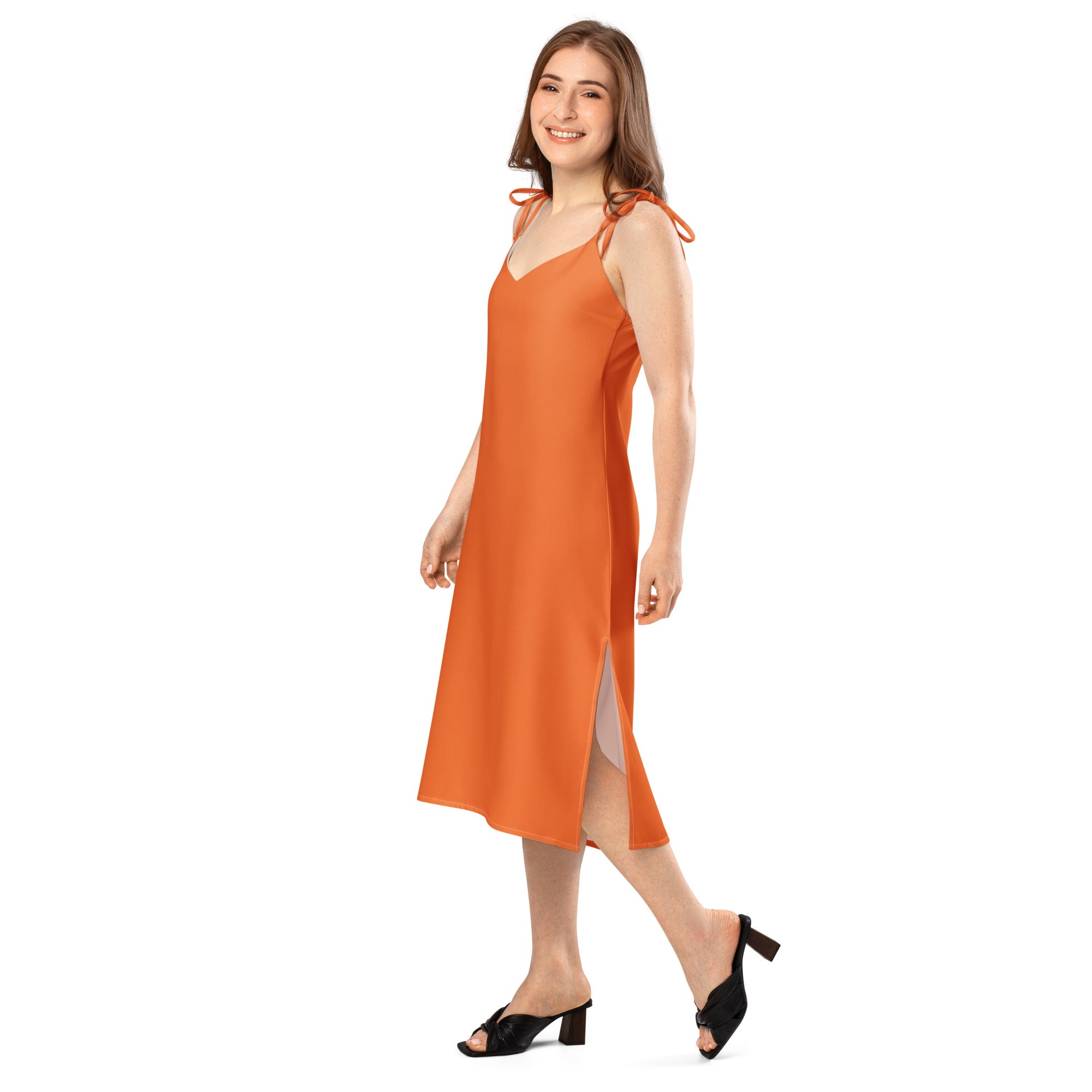 Woman wearing an orange slip dress on a white background