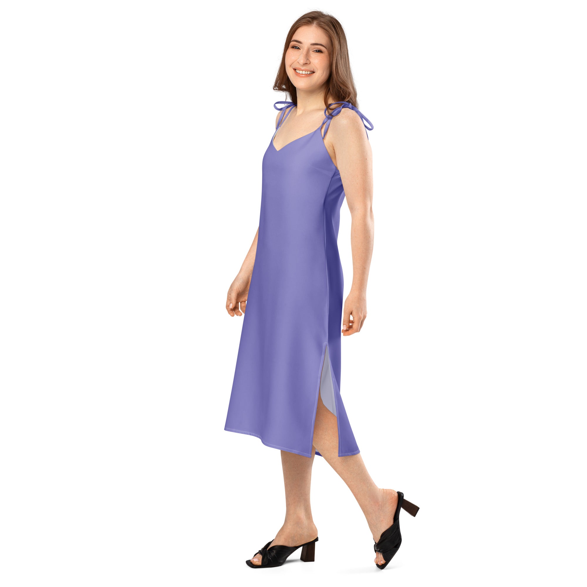 Woman wearing a purple slip dress on a white background