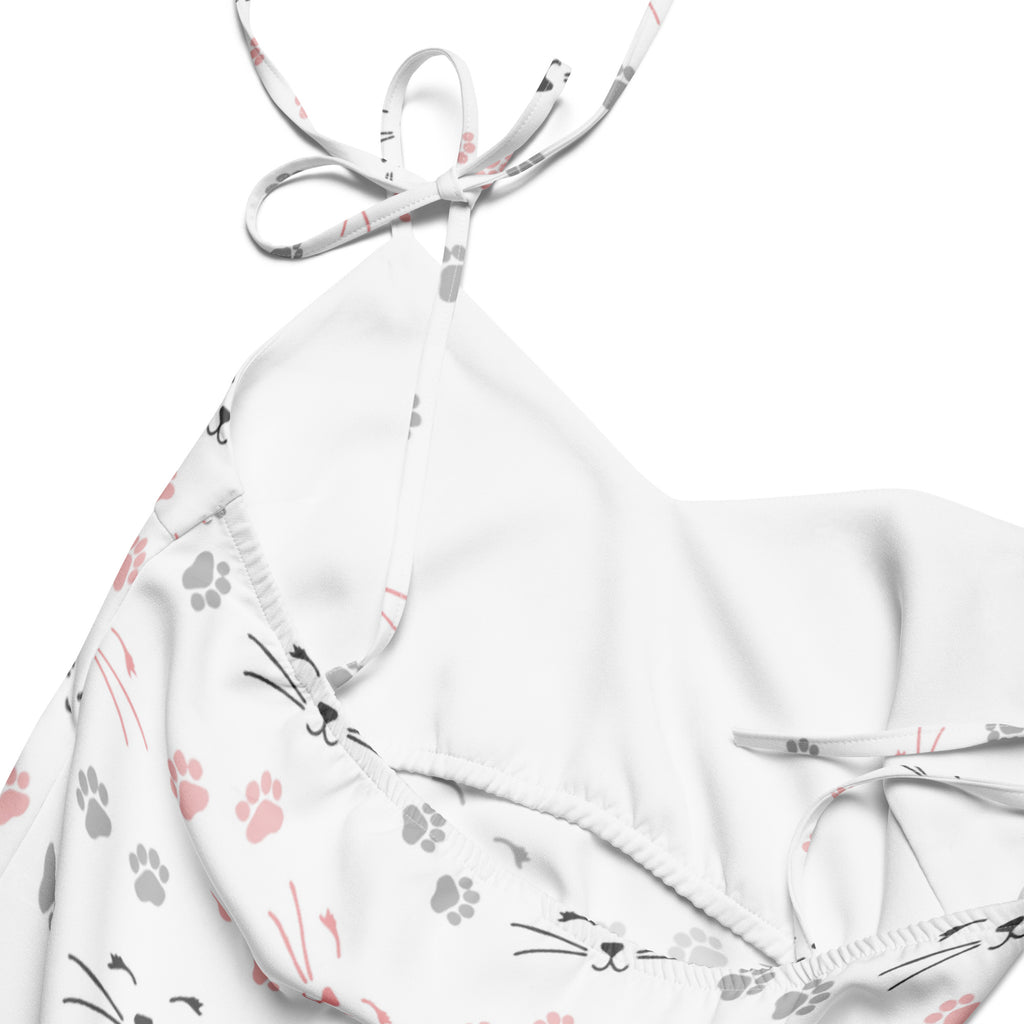 Women’s white halter top bikini with pink and gray cat paw prints and whisker faces on soft fabric