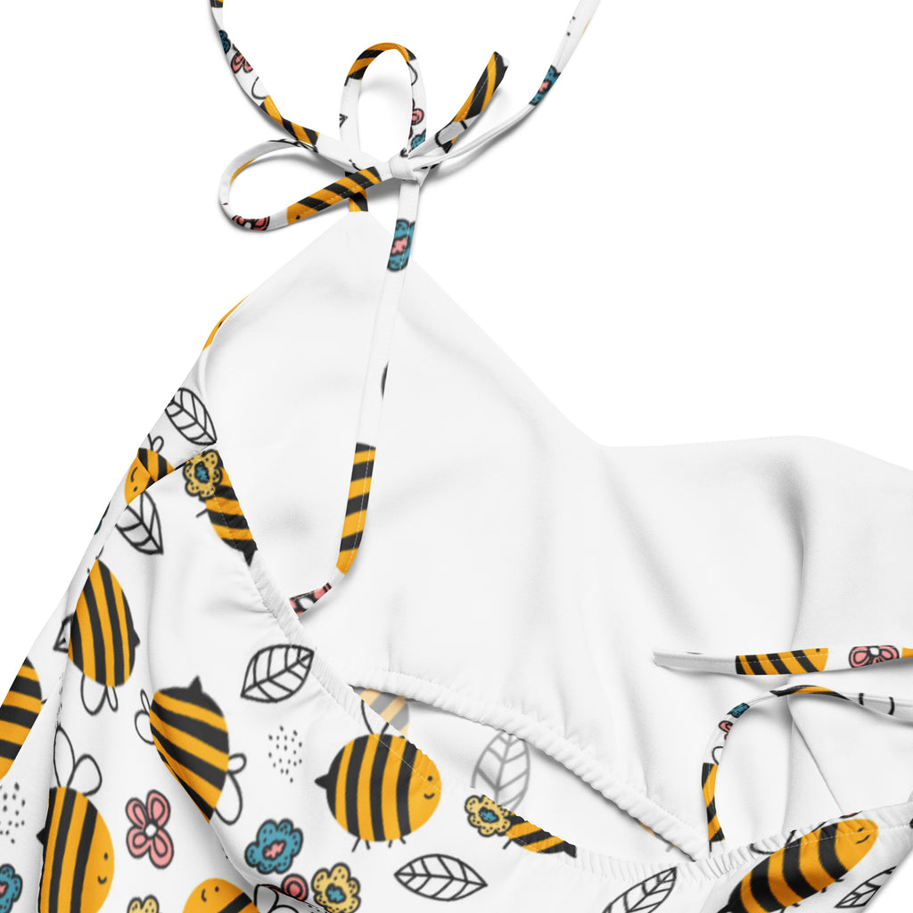 White halter top bikini with yellow and black cartoon bees flowers and leaves on stretchy fabric