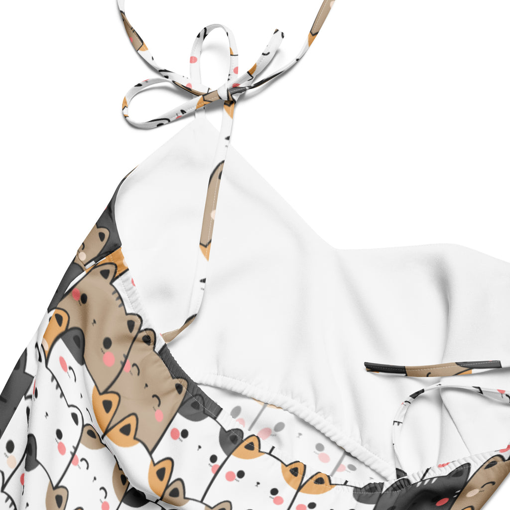 White halter top bikini with cartoon cats pattern for women featuring adjustable tie straps and built in bra