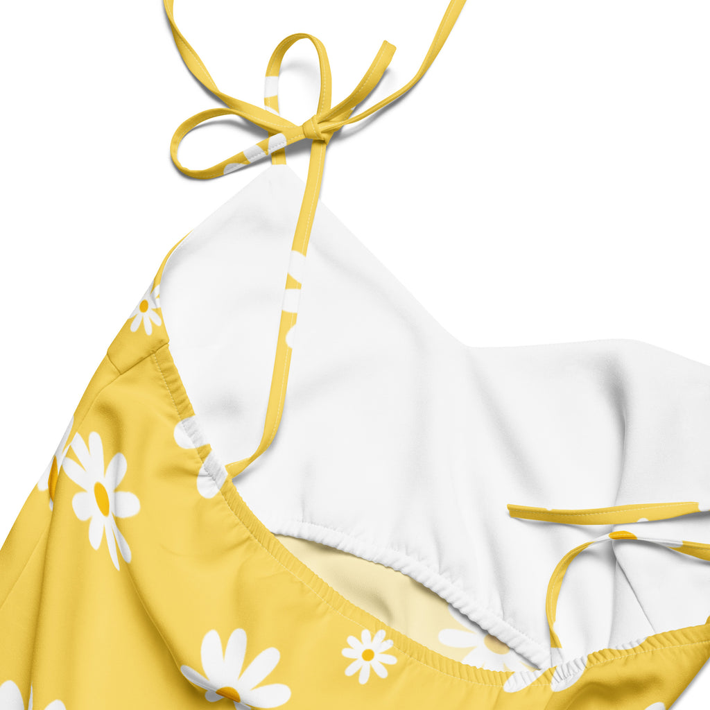 Yellow and white daisy-patterned bikini top with adjustable yellow ties perfect for summer and beachwear