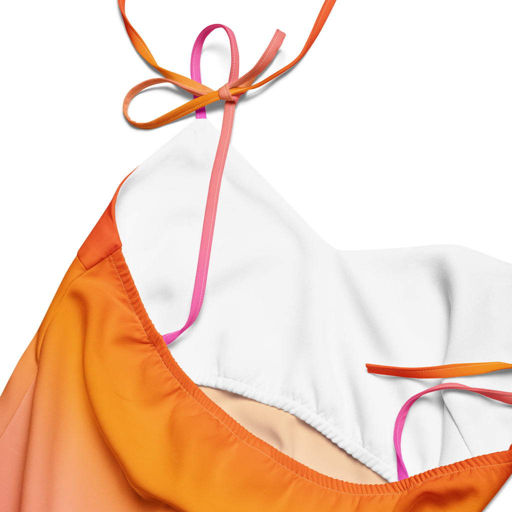 A vibrant orange and white gradient bikini top with halter neck and adjustable straps, matching the sunset ombre midi dress