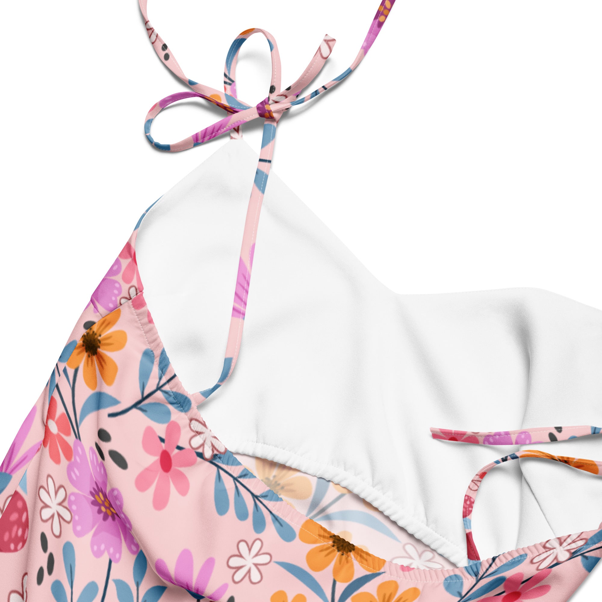 Women’s pink floral slip dress with midi length adjustable tie straps and built in bra featuring colorful flowers
