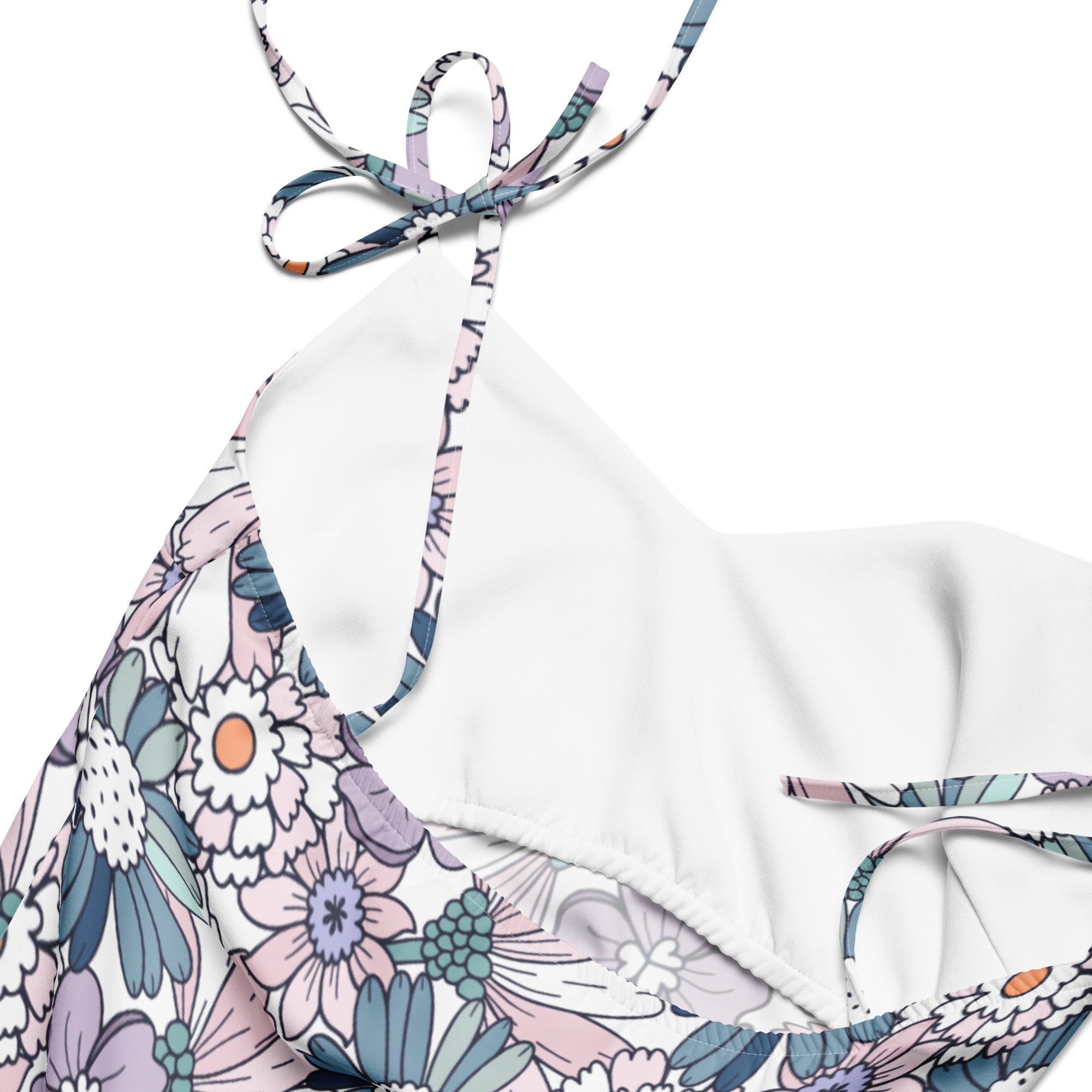 White halter top bikini with pastel floral pattern in pink lavender and teal paired with a womens pastel floral slip dress