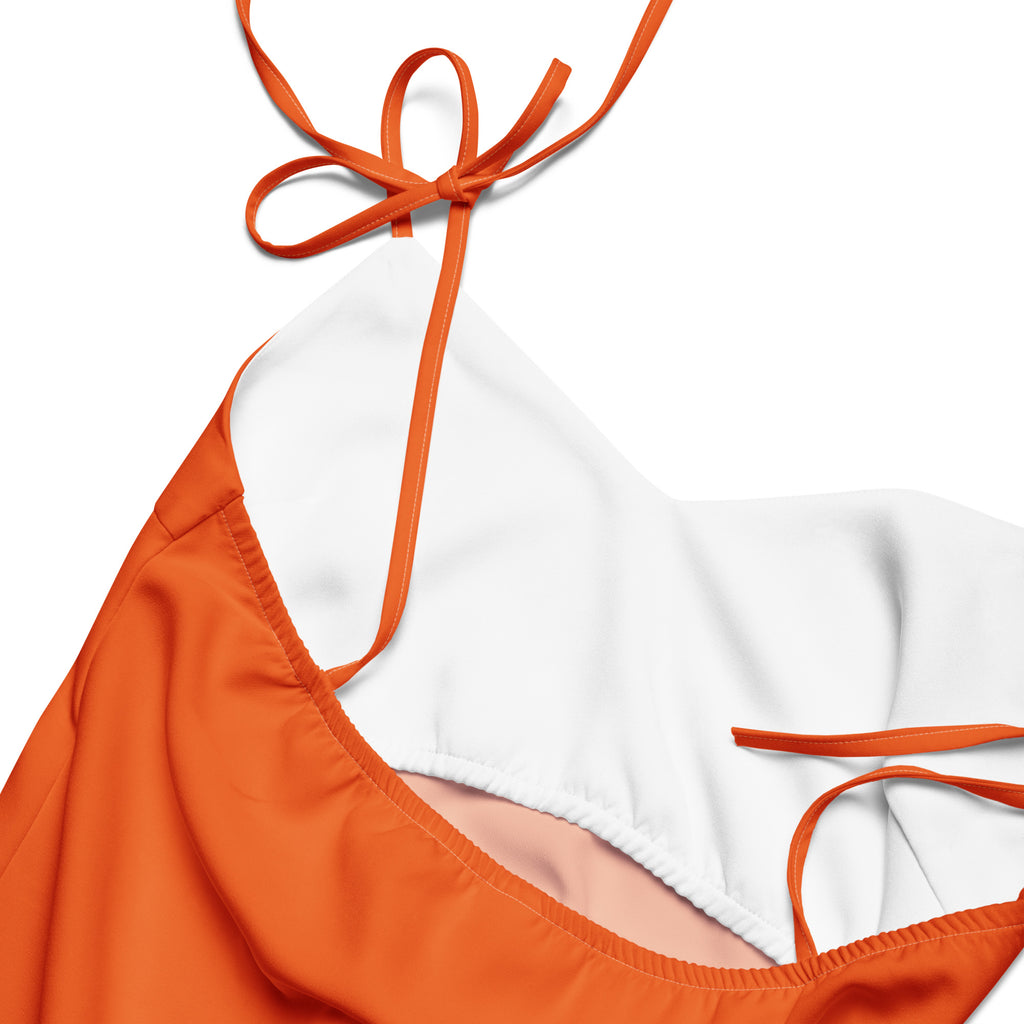 Orange dress with white strap on a white background