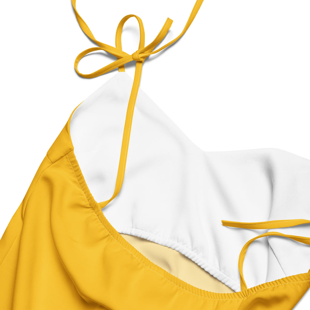 Women's yellow slip dress with adjustable tie straps and built-in bra.