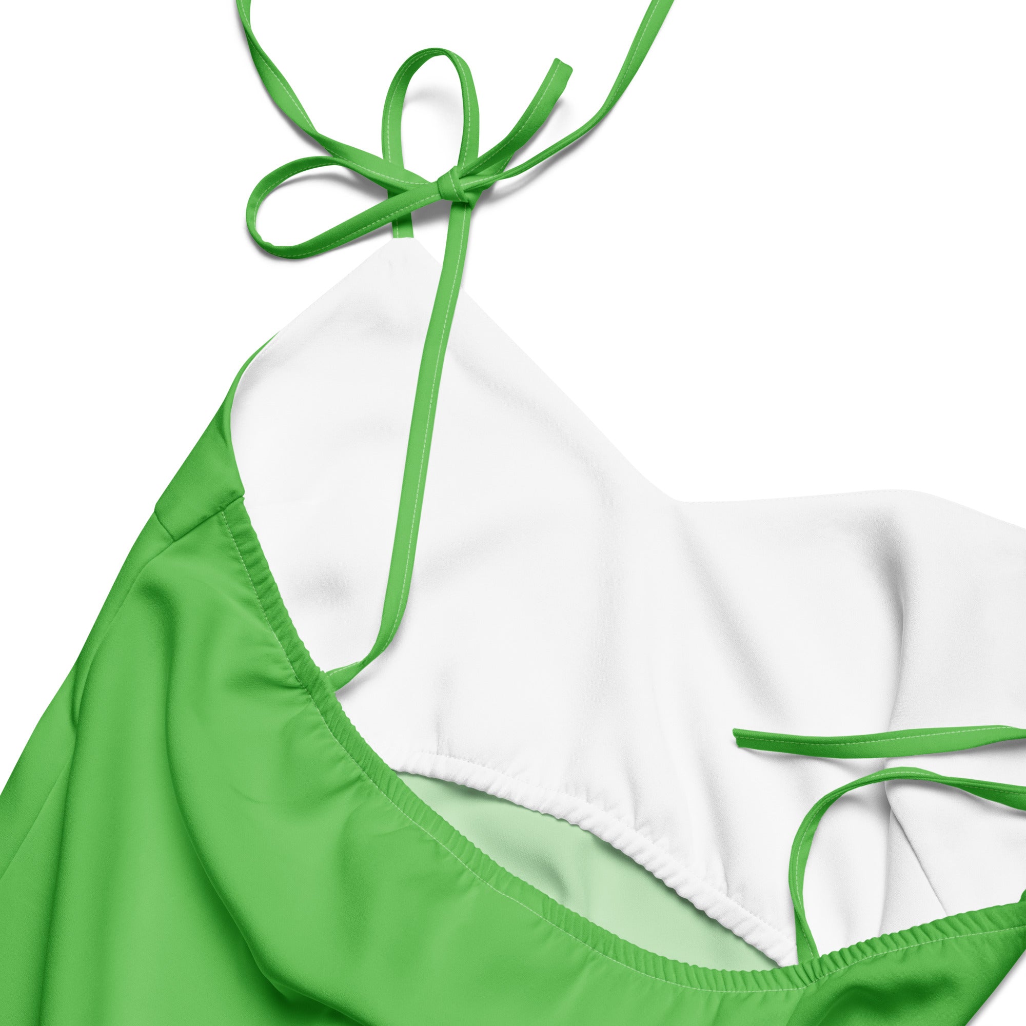 Women's green slip dress with built-in bra, white lining, and adjustable tie straps