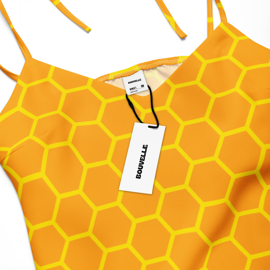 Women’s vibrant orange and yellow hexagonal patterned top with thin straps and bouvelle brand tag