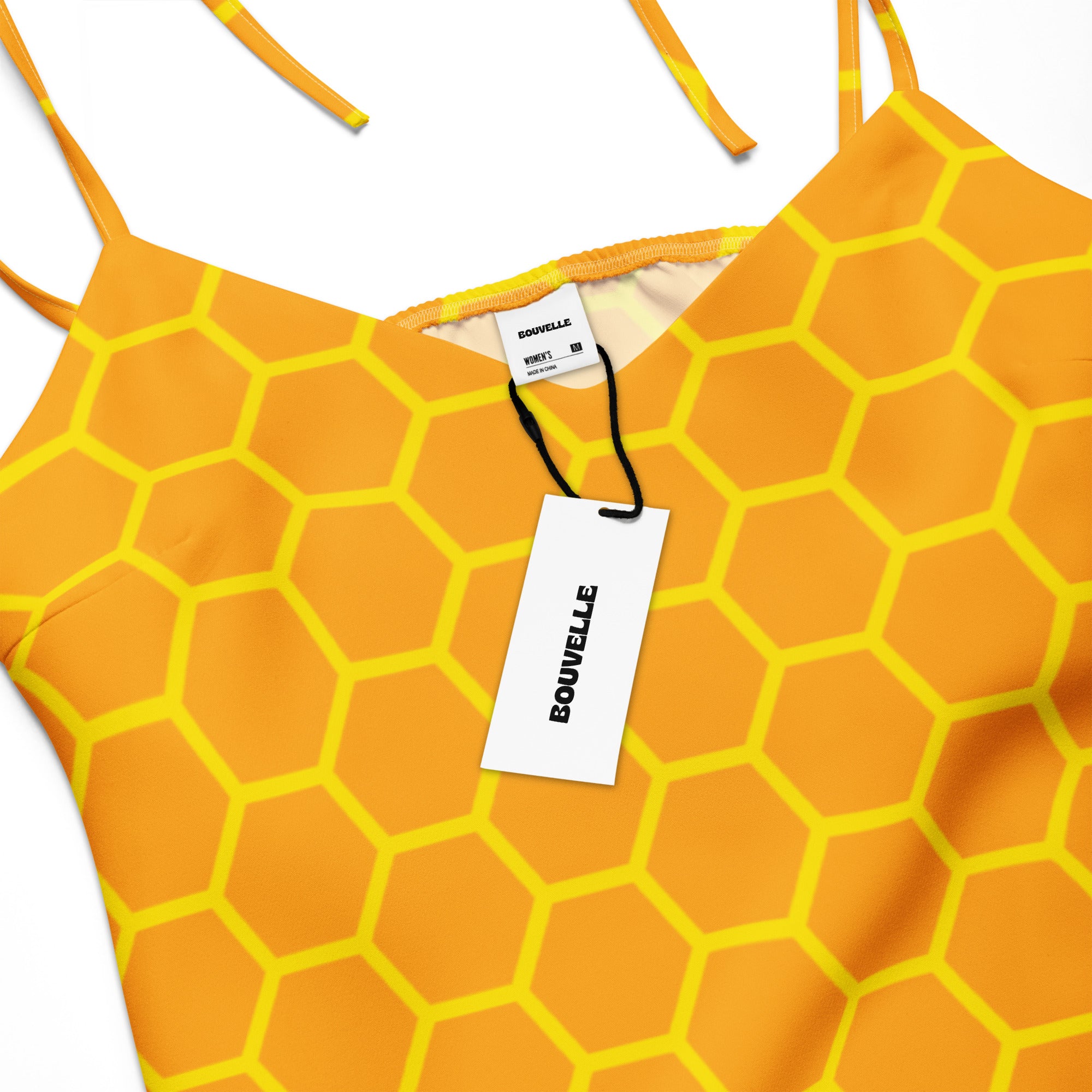 Women’s vibrant orange and yellow hexagonal patterned top with thin straps and bouvelle brand tag