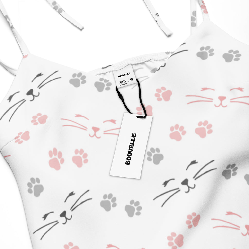 White spaghetti strap midi slip dress with adjustable tie straps featuring pink and gray cat faces and paw prints