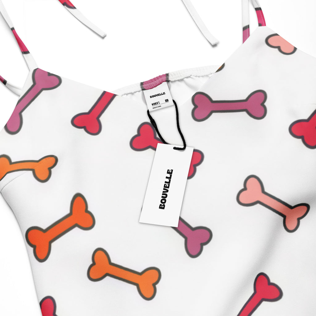 Women’s colorful midi slip dress with adjustable tie straps built-in bra and playful pink red orange dog bone pattern