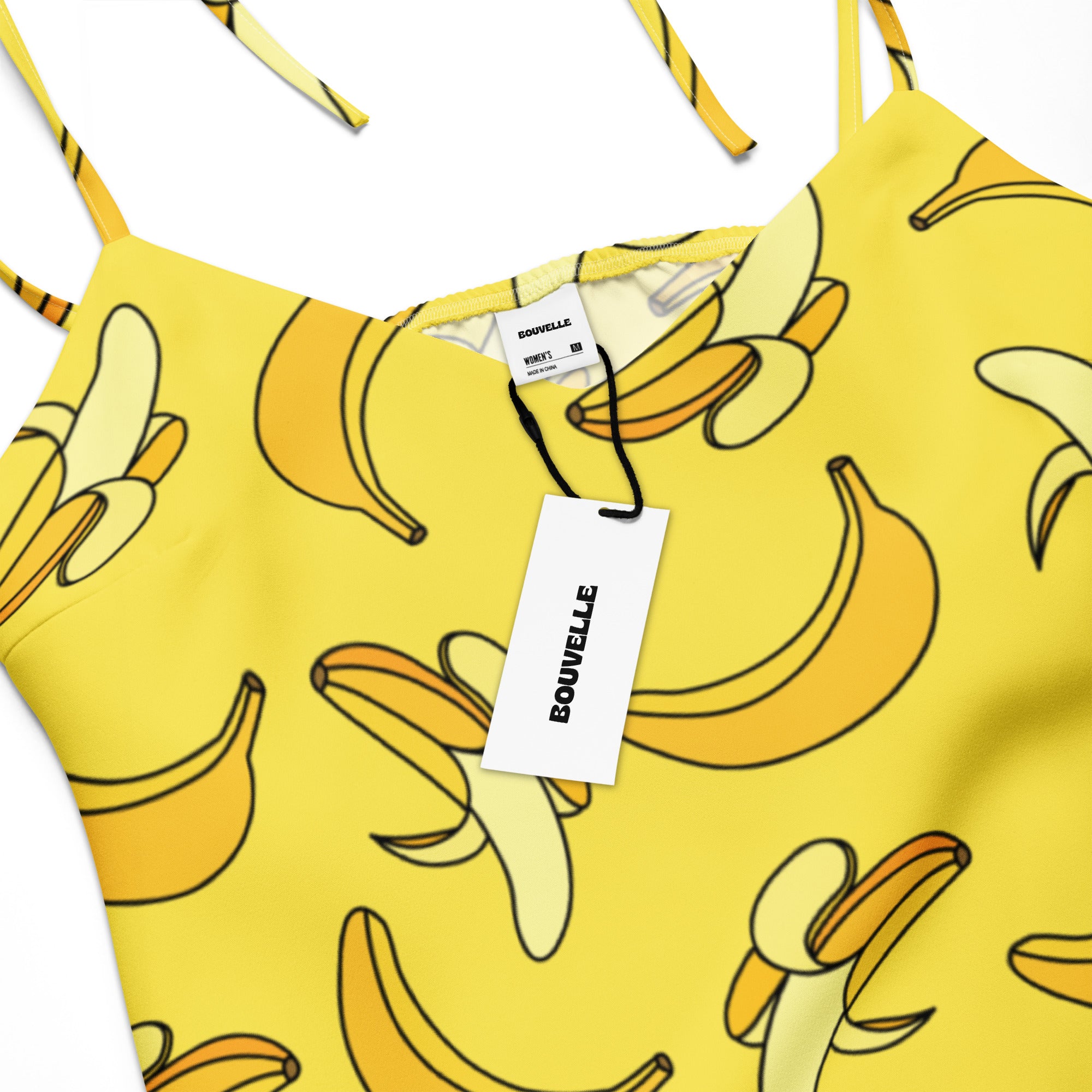 Yellow dress with banana pattern and Bouvelle tag on a white background