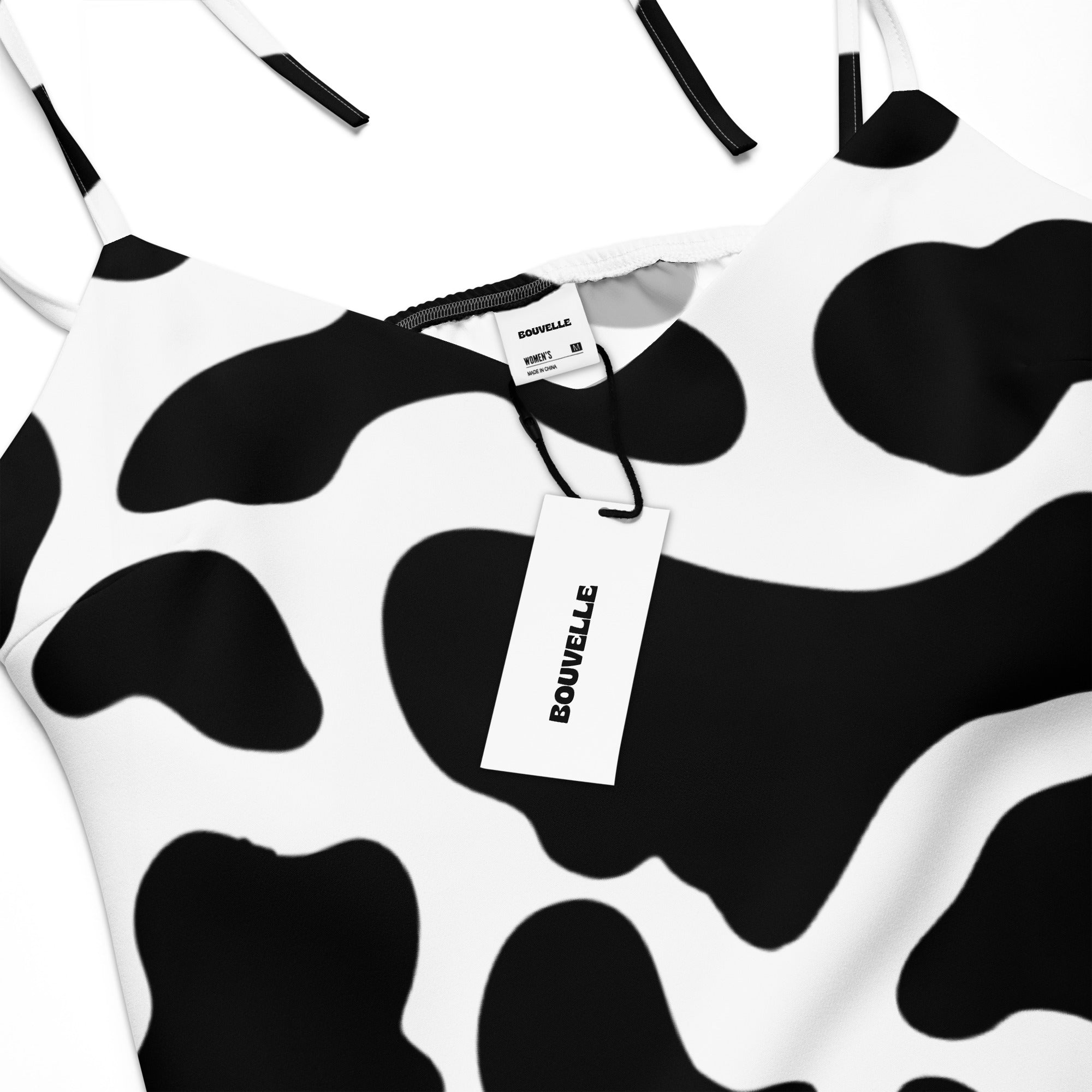 Cow print dress with a visible brand tag on a white background