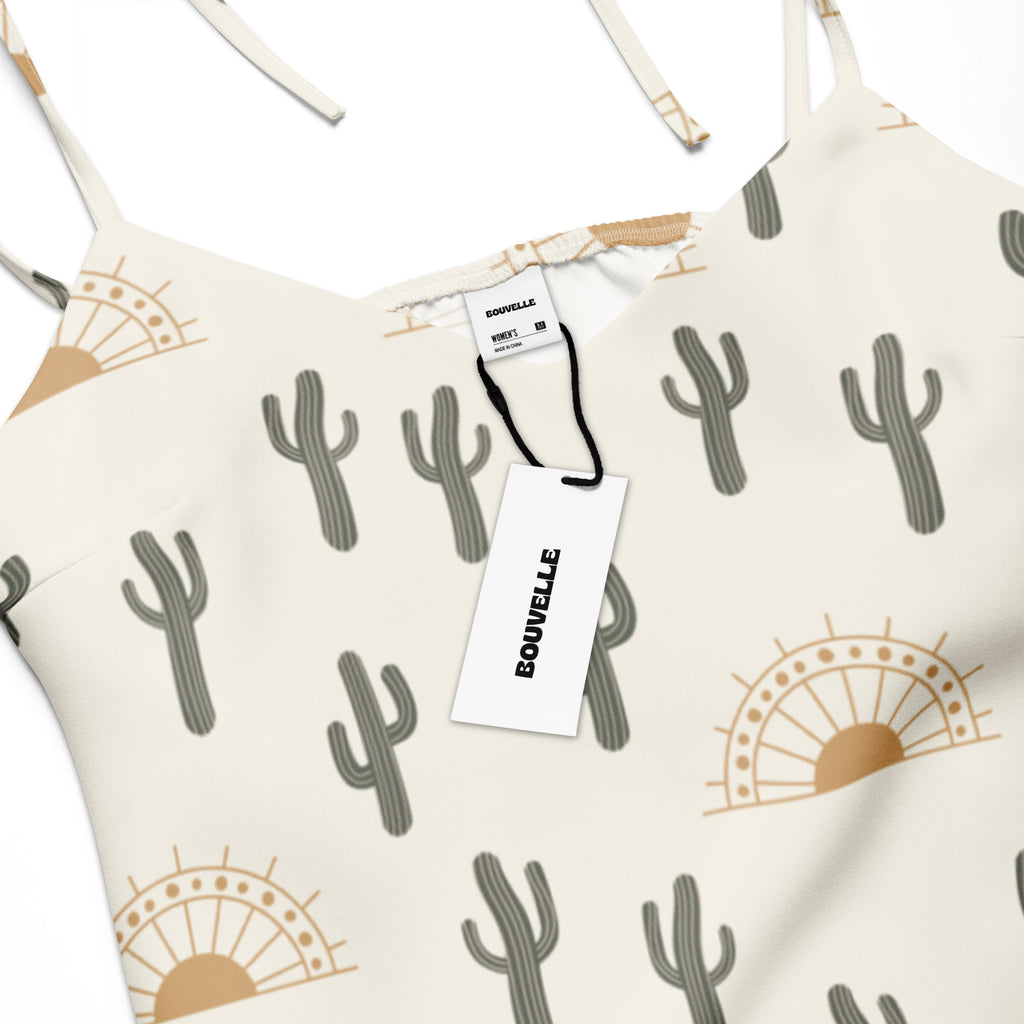 Cream-colored women’s midi slip dress with adjustable tie straps and gray cactus tan sun pattern featuring built-in bra
