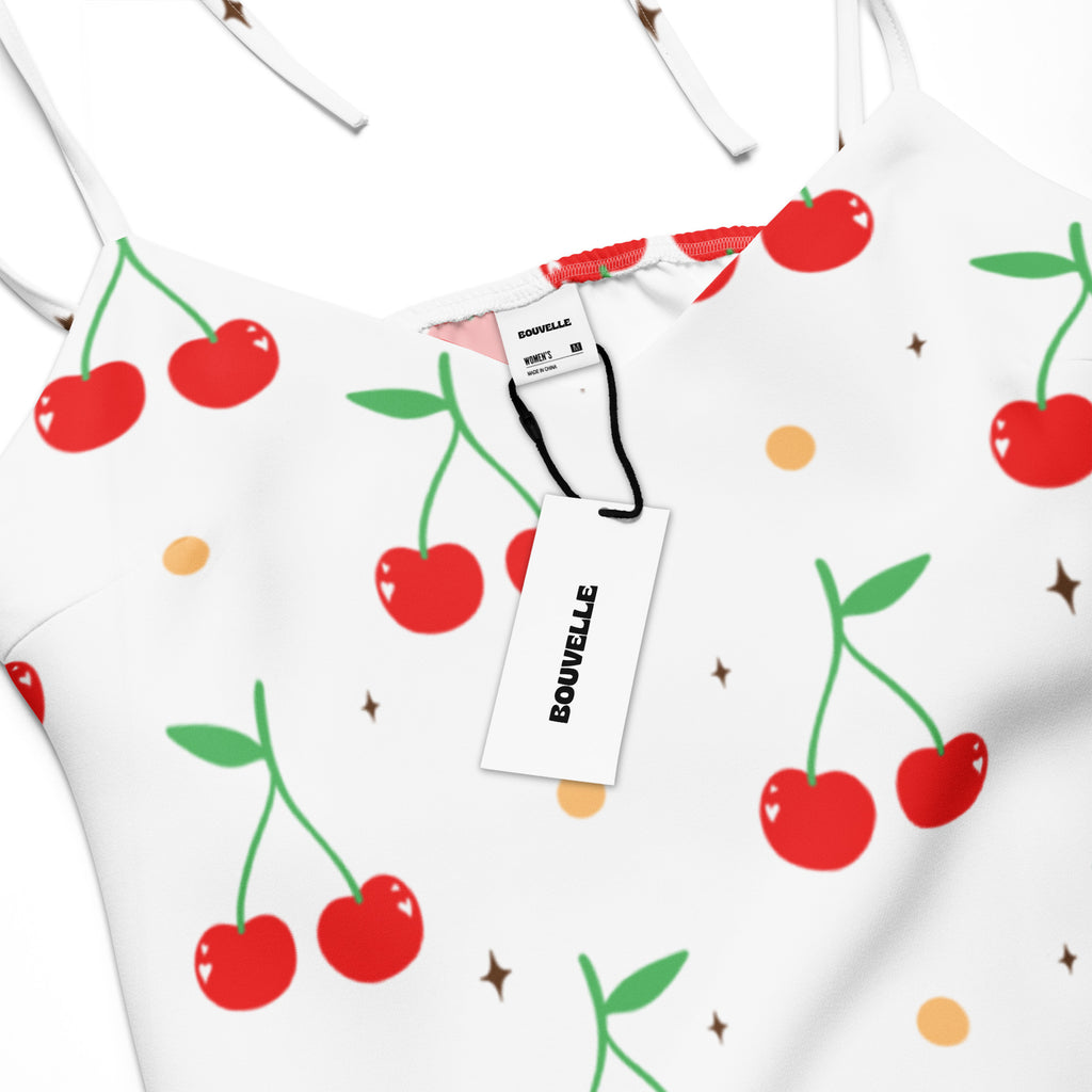 White cherry print slip dress midi with adjustable tie straps featuring red cherries green stems gold dots and brown stars