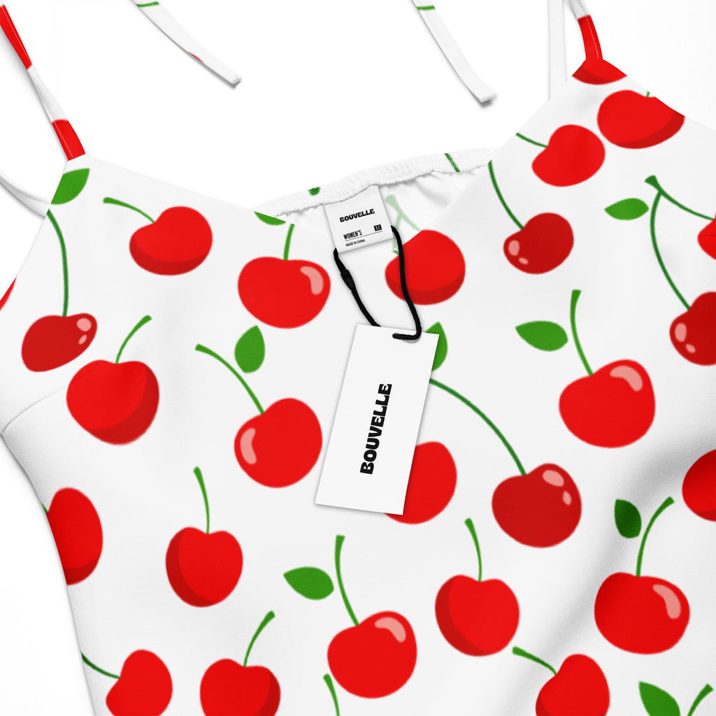 White spaghetti strap top with red cherry and green leaf pattern featuring adjustable tie straps and built in bra