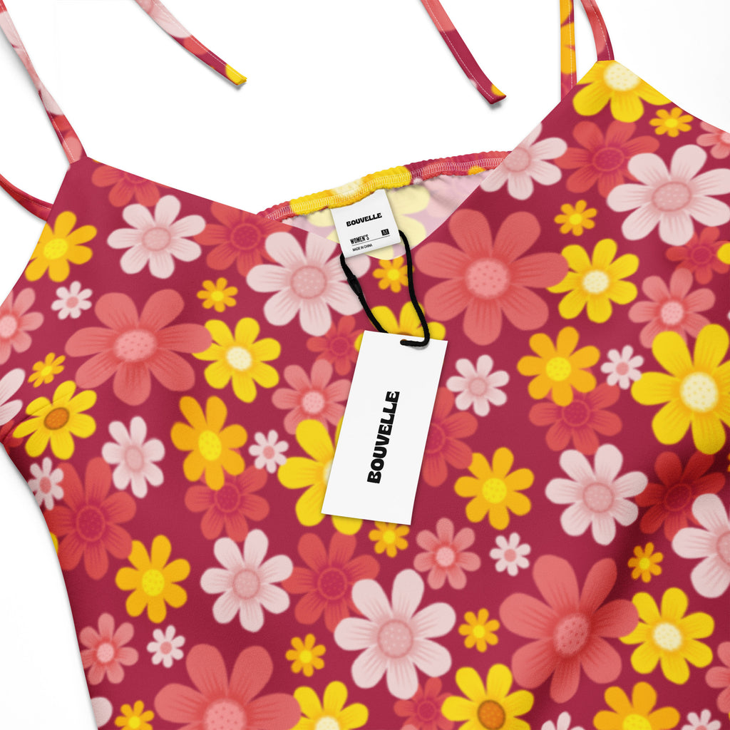 Women’s red floral slip midi dress with adjustable tie straps and built in bra shown with vibrant pink and yellow daisy bikini top