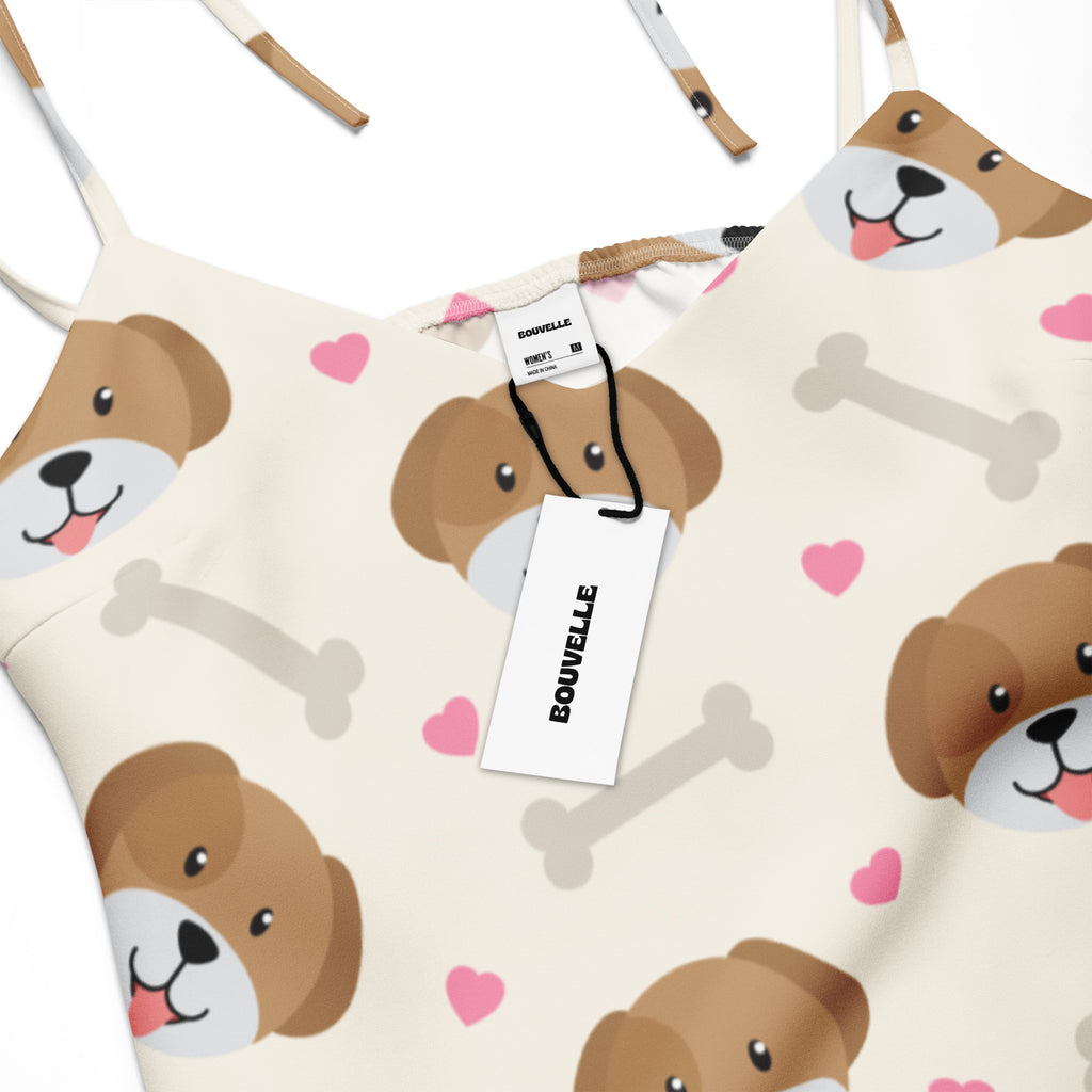 Cream-colored women’s midi slip dress with adjustable tie straps and cute brown dog face, pink heart, and gray bone print