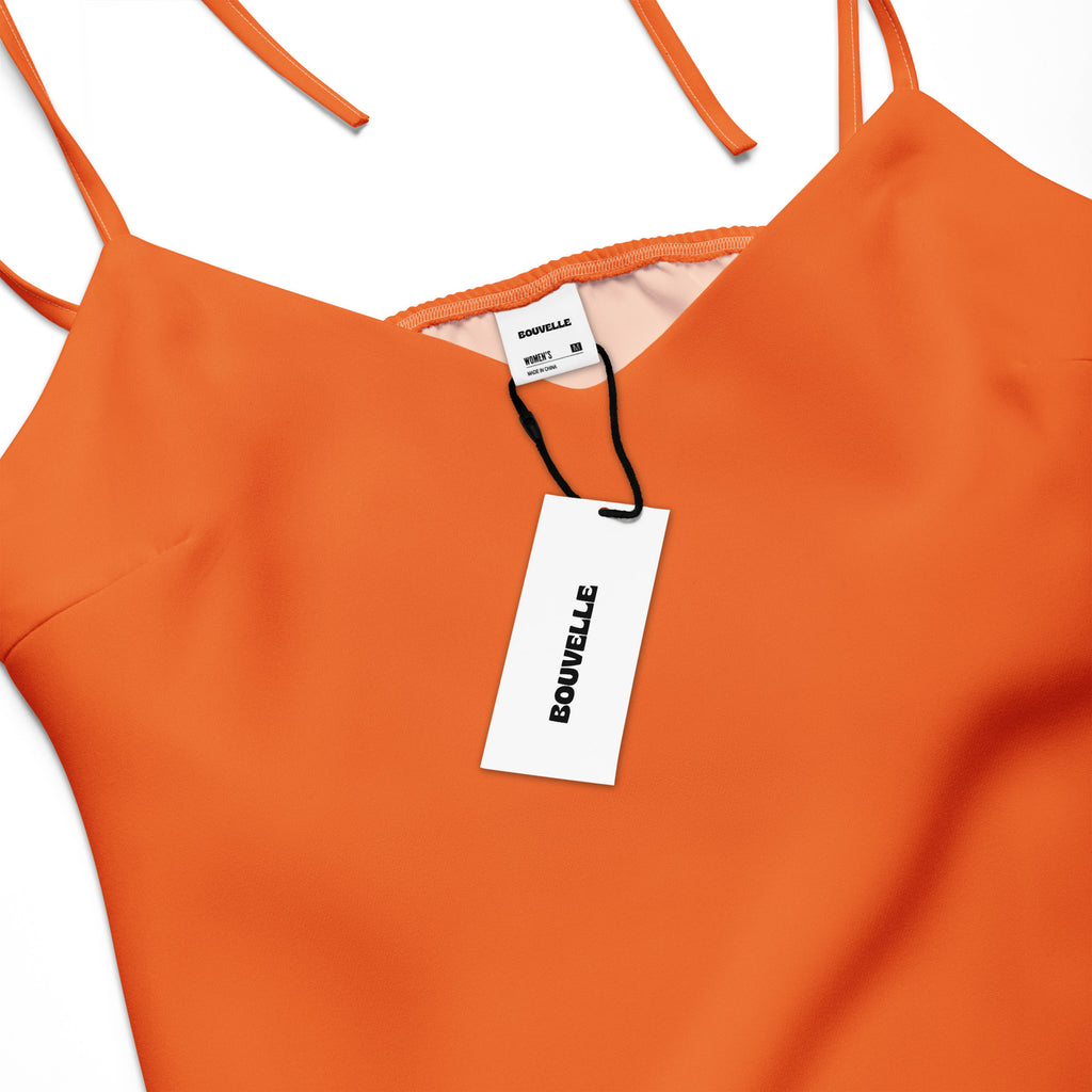 Orange dress with a visible brand tag on a white background