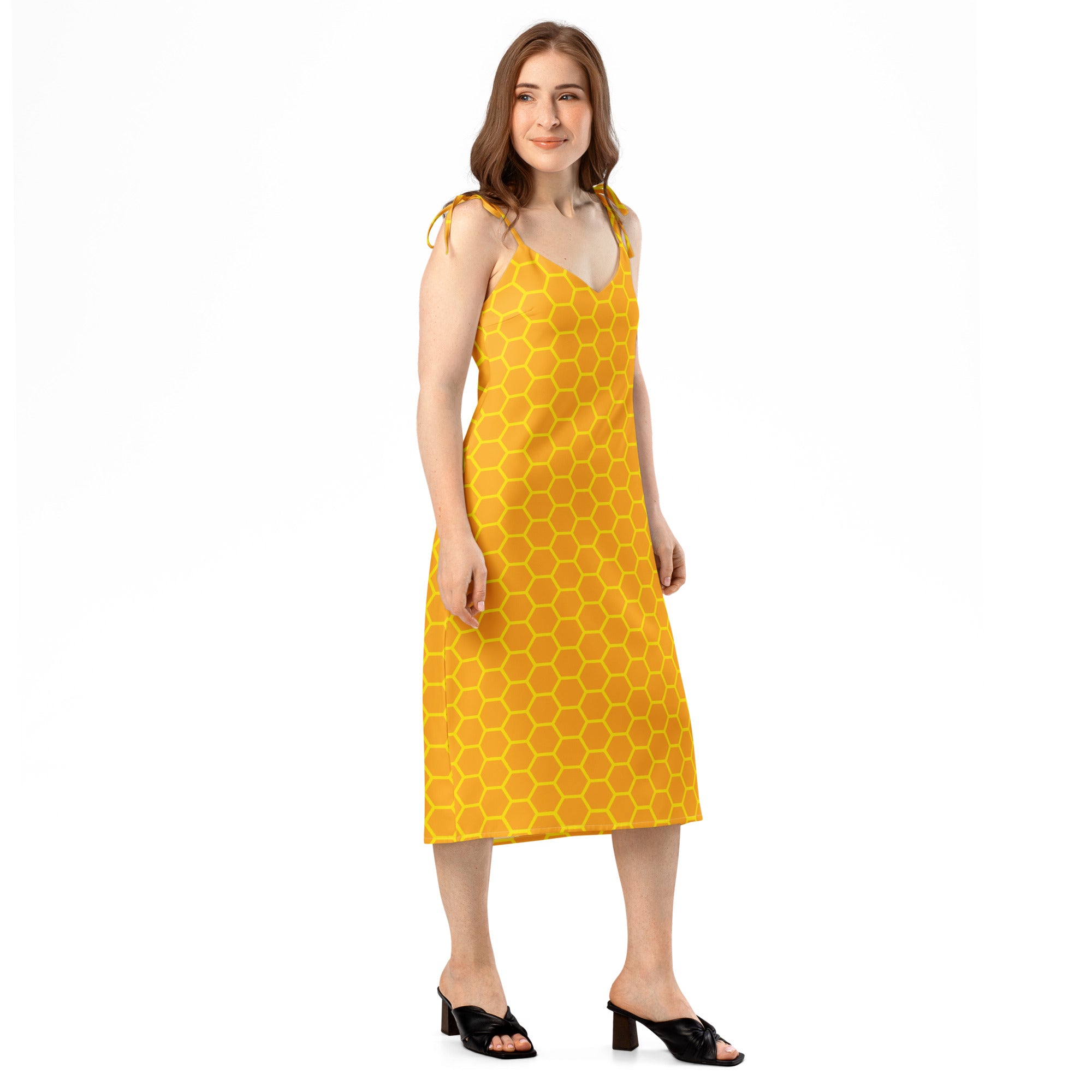 A vibrant yellow midi dress with a bold honeycomb pattern and delicate shoulder ties for women