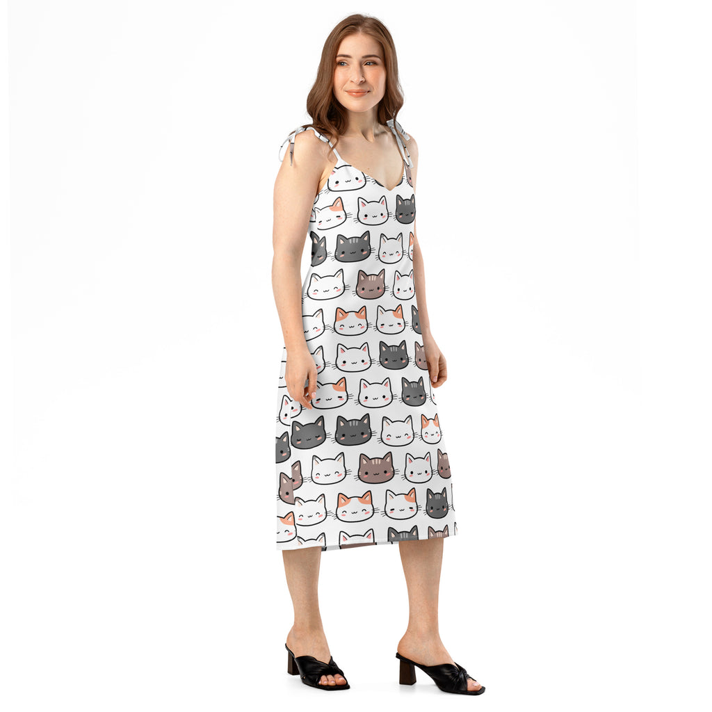 White sleeveless midi slip dress with playful cartoon cat pattern adjustable tie straps and built in bra