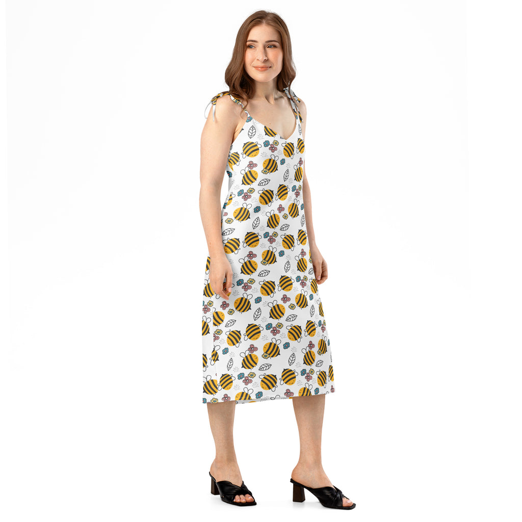 White sleeveless midi dress with yellow and black bumblebee floral pattern adjustable tie straps and built in bra