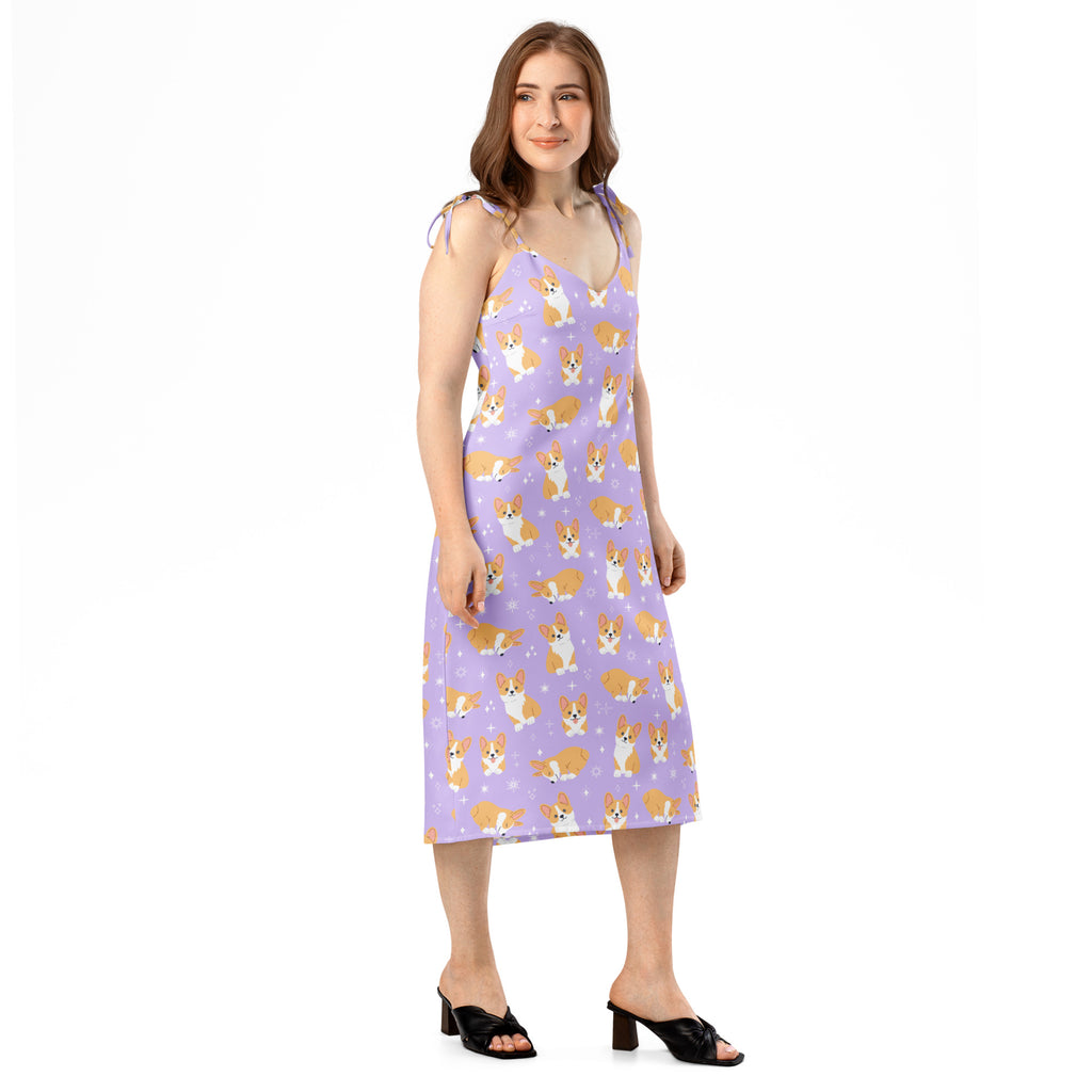 Woman wearing a sleeveless dress with corgi pattern on a white background