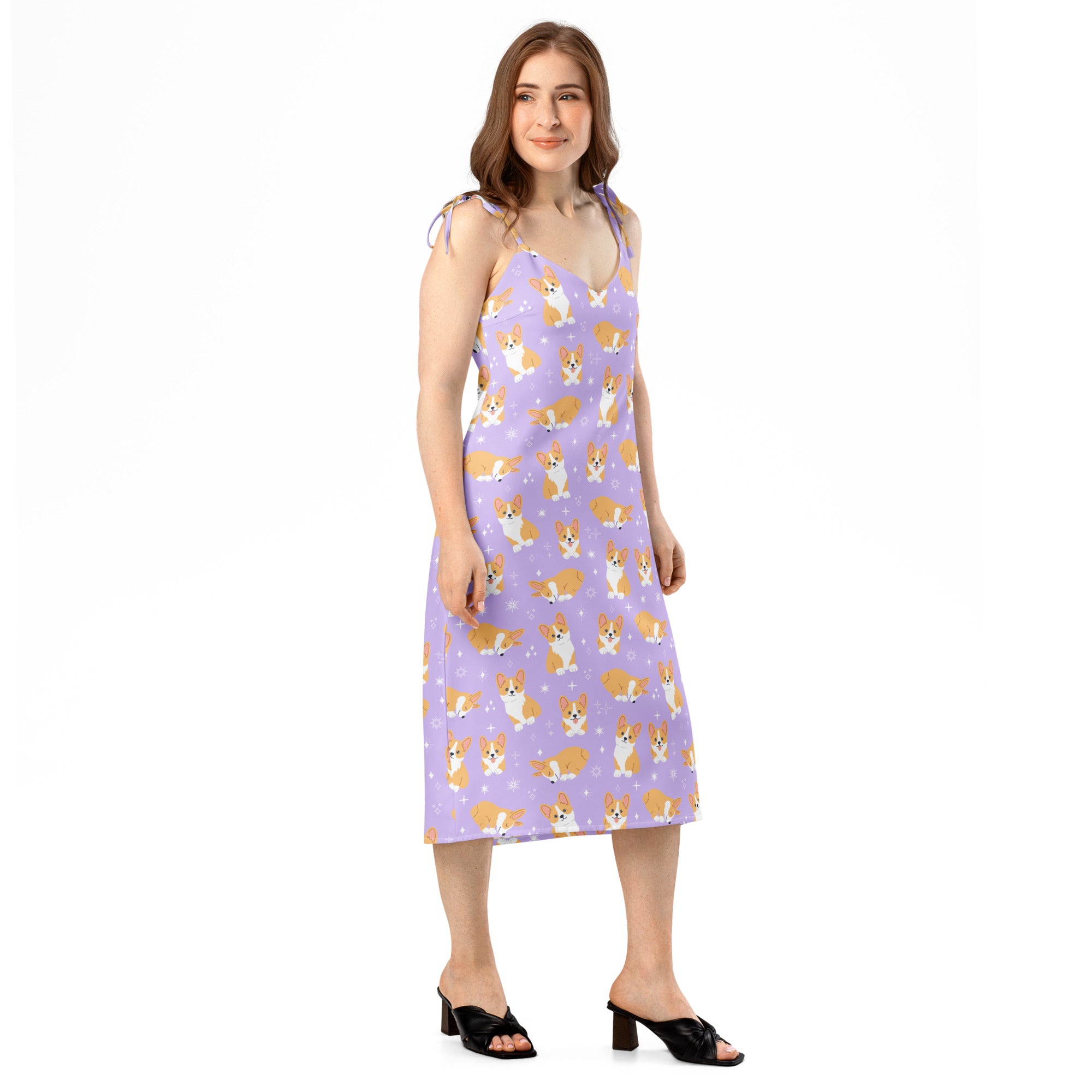 Woman wearing a sleeveless dress with corgi pattern on a white background