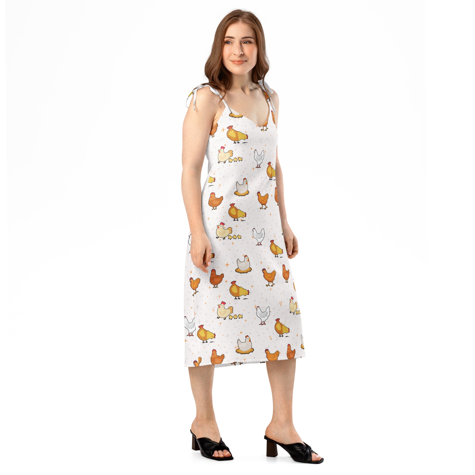 Woman wearing a sleeveless dress with chicken pattern on a white background