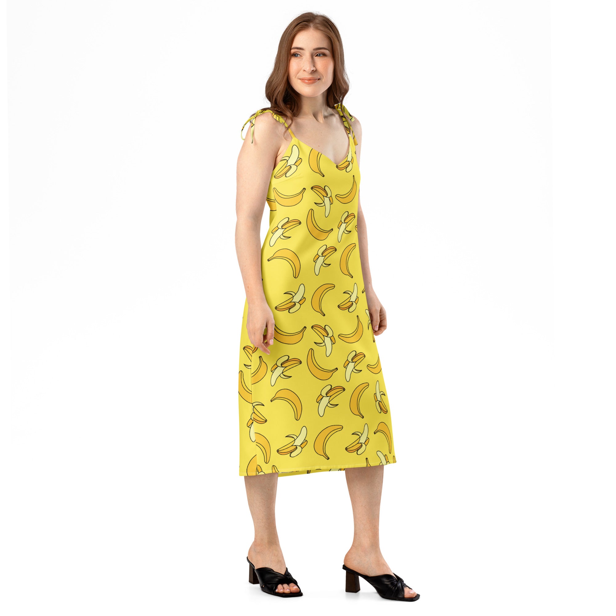 Woman wearing a yellow dress with banana pattern on a white background