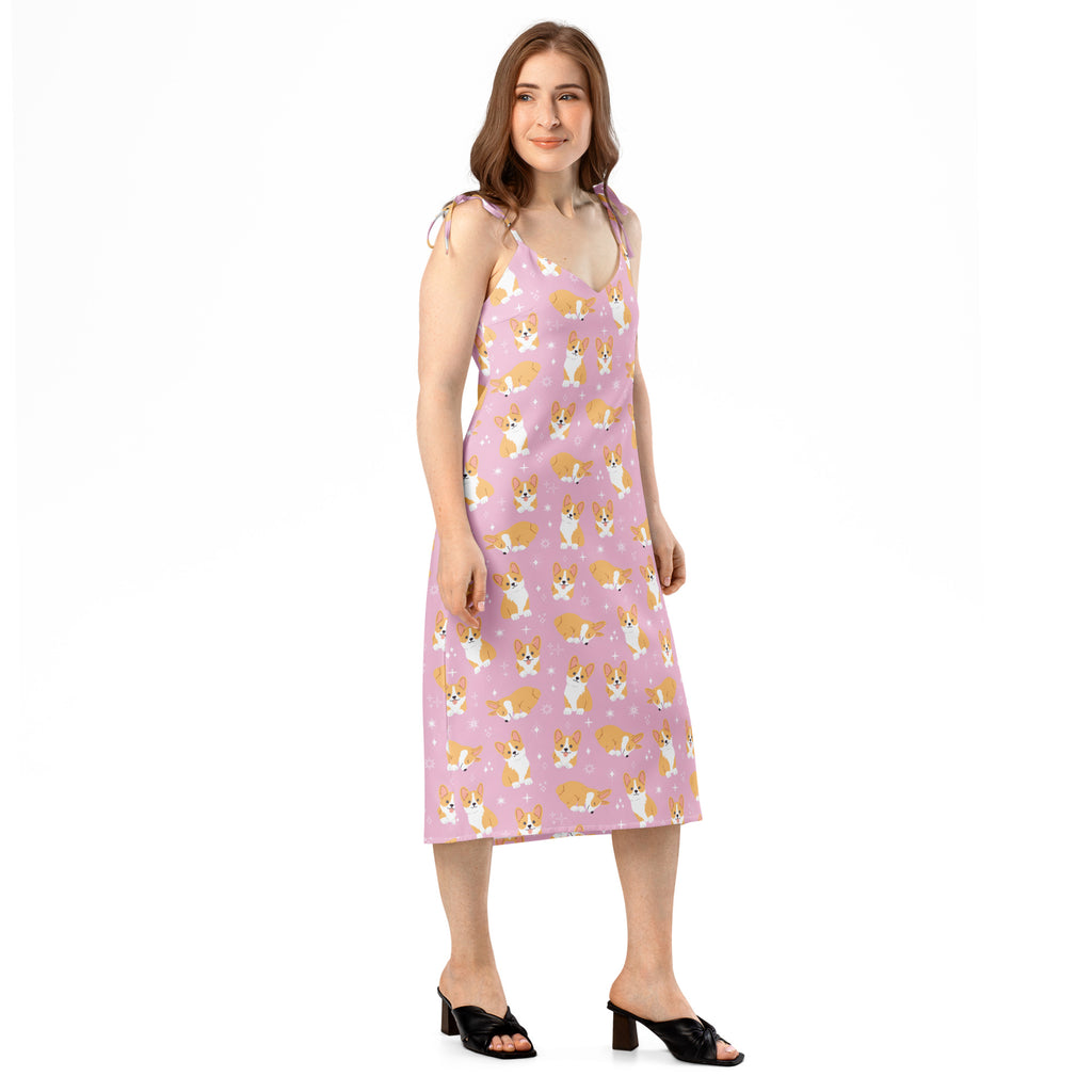 Woman wearing a pink dress with dog pattern on a white background