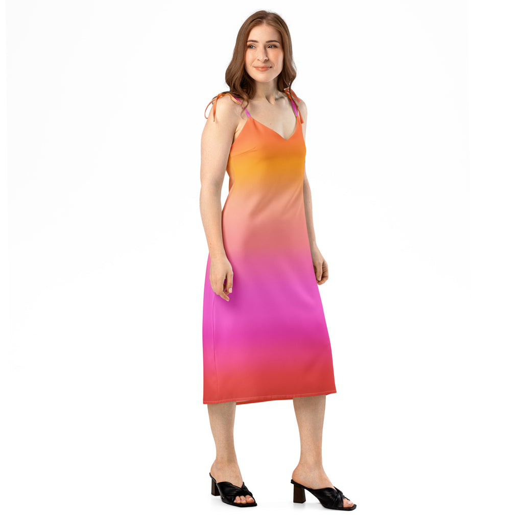 A vibrant orange pink and red women’s sunset ombre midi slip dress with adjustable tie straps and built-in bra