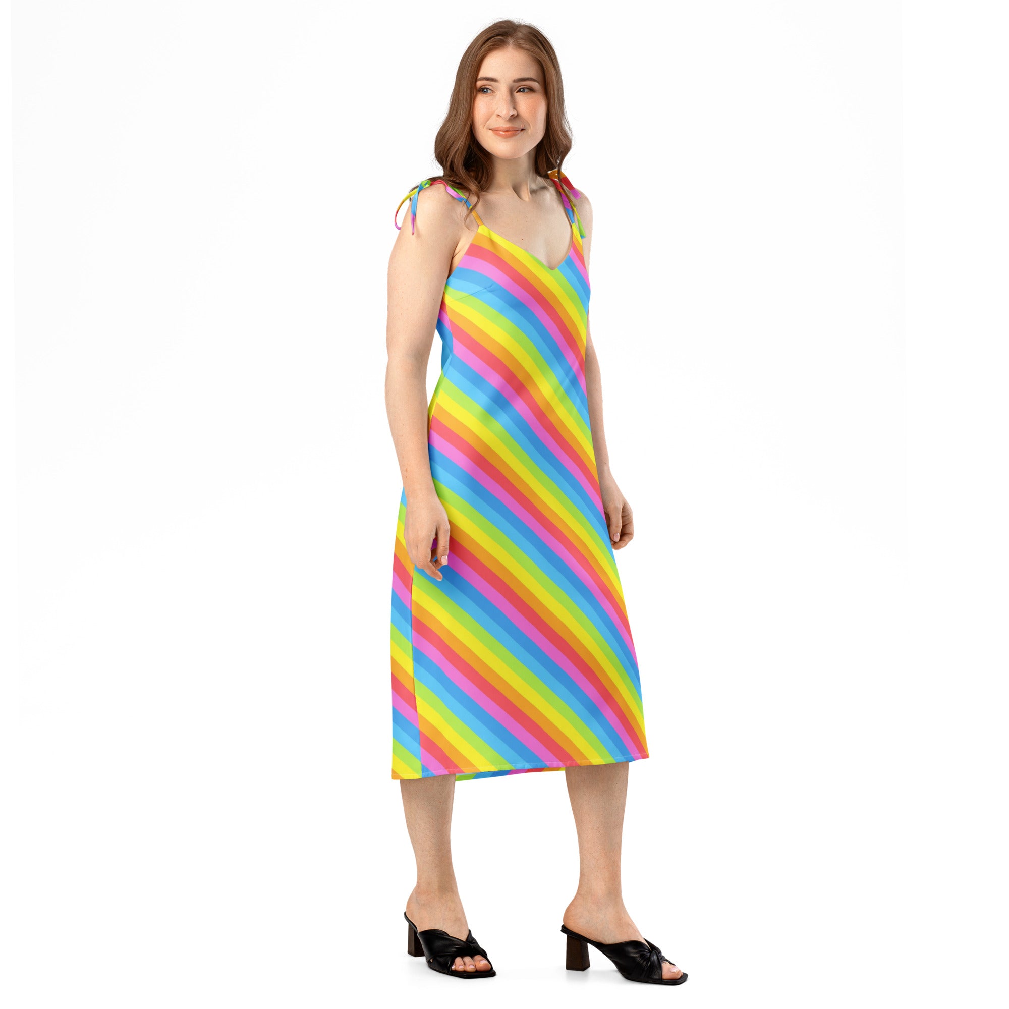 A vibrant rainbow stripe midi slip dress with thin adjustable tie straps and built-in bra shown from the back