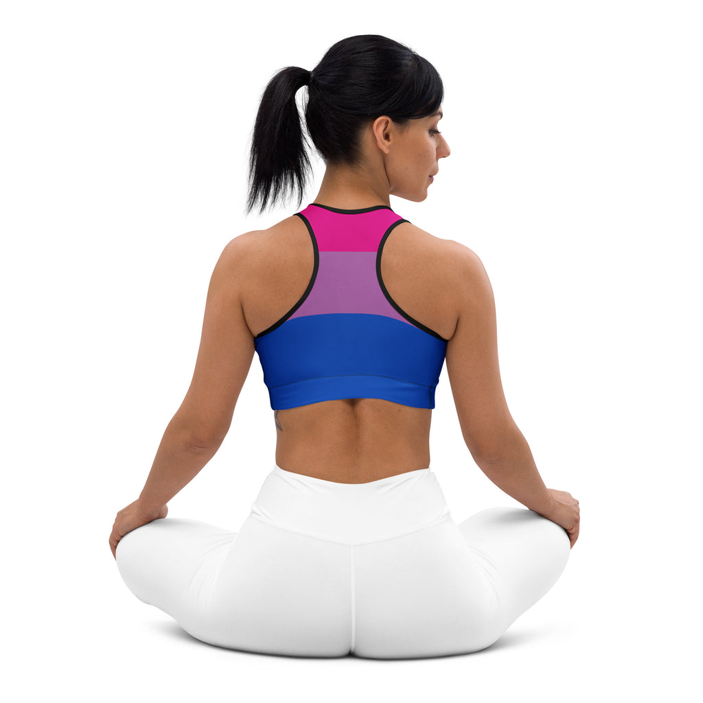 A vibrant bi-pansexual pride-colored women’s quick drying sports bra with sleek black trim and form-fitting design