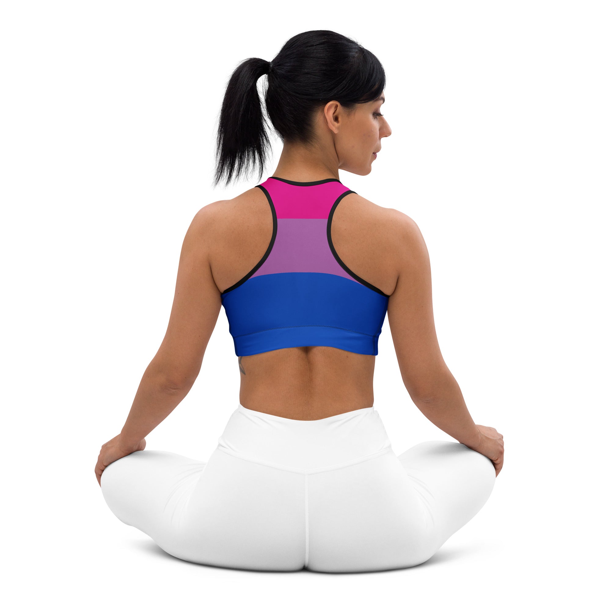 A vibrant bi-pansexual pride-colored women’s quick drying sports bra with sleek black trim and form-fitting design