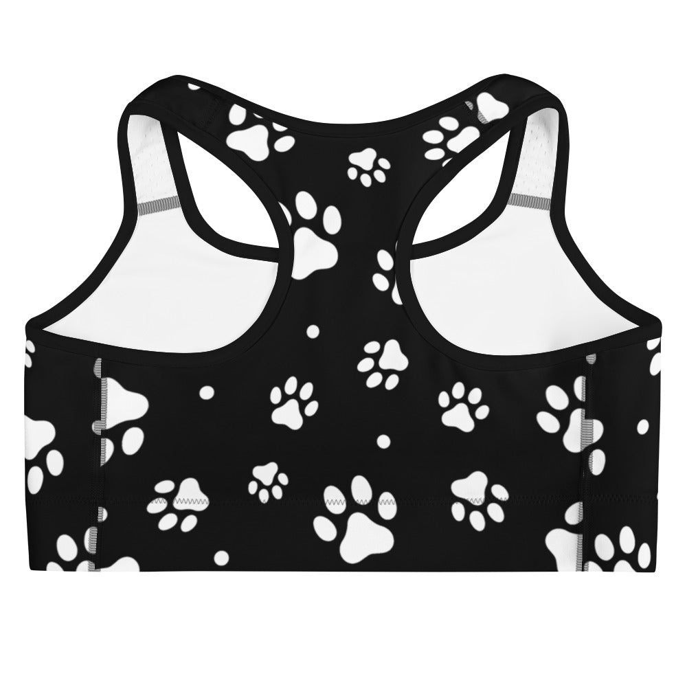 Black women’s quick drying sports bra with white paw print pattern for active wear