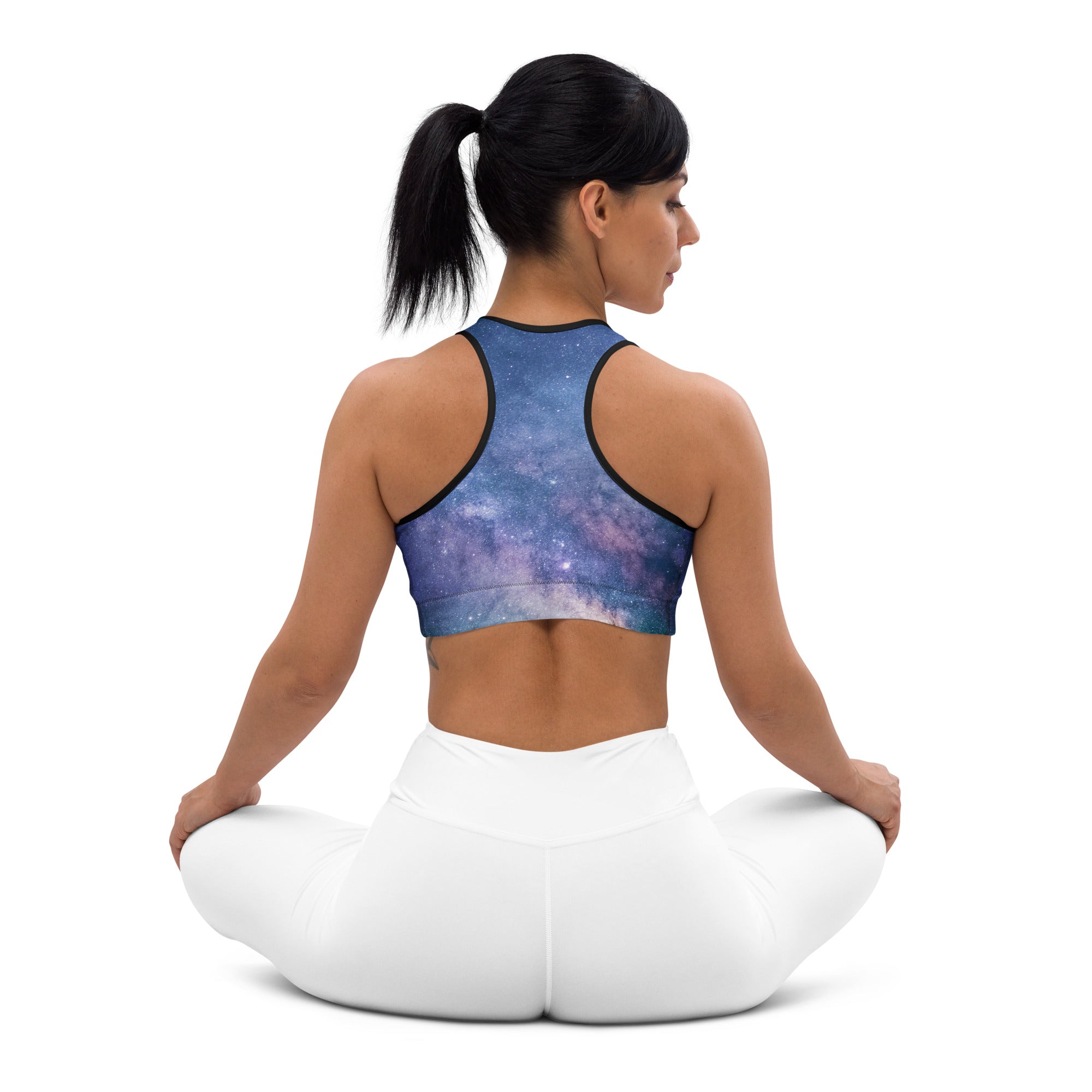 Women’s realistic galaxy quick drying sports bra in blue and purple with black trim for activewear use