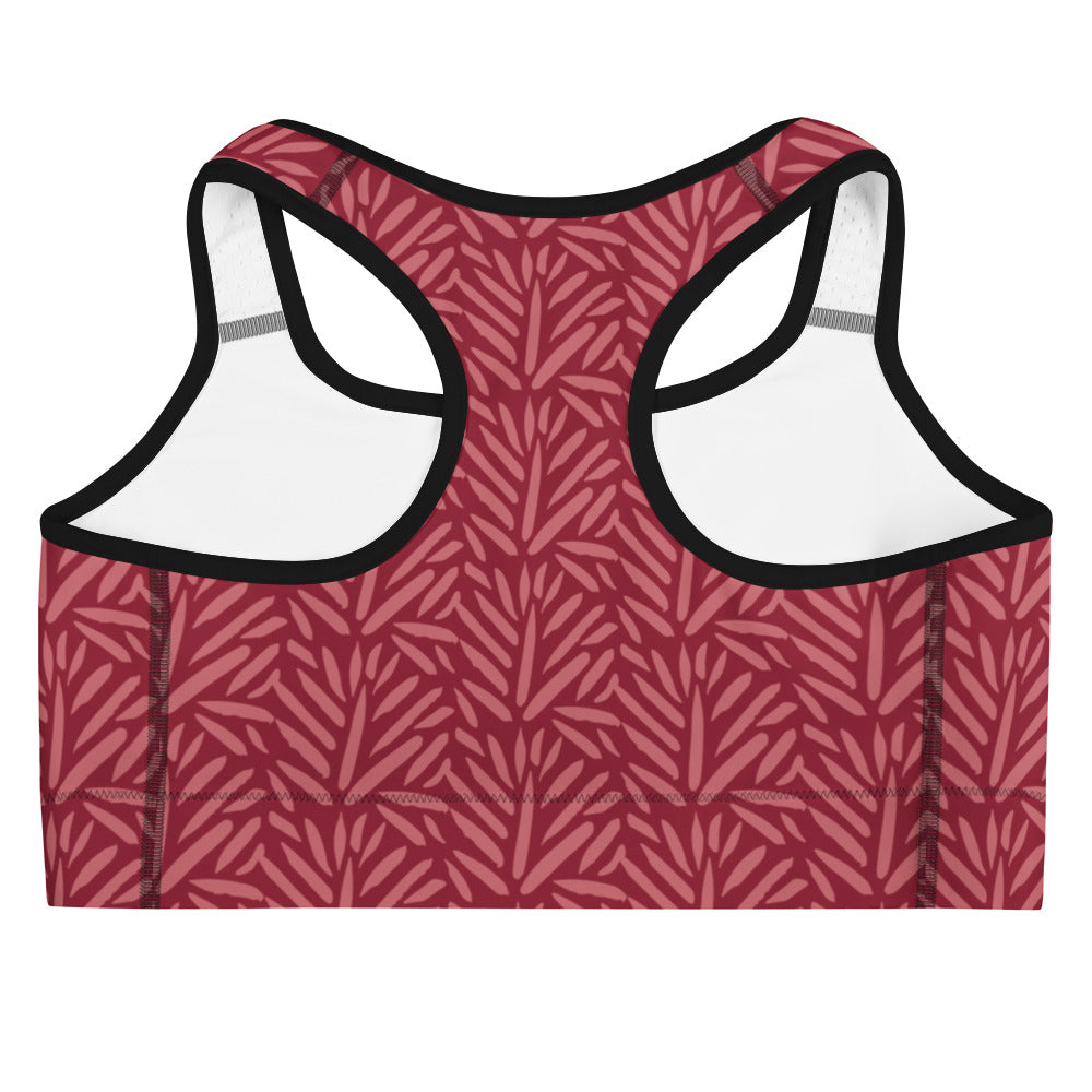 Women’s burgundy leaf quick drying sports bra in maroon with leafy pattern and black trim for active wear