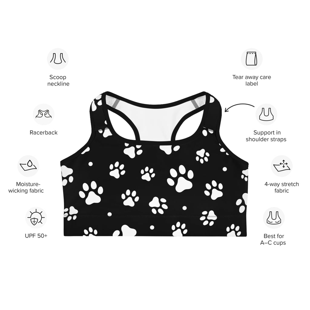 Black quick drying women’s sports bra with white paw print pattern and racerback design shown from the back side