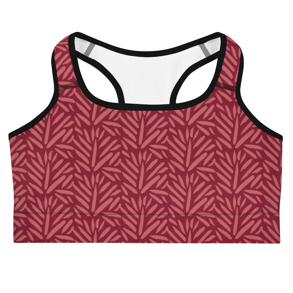 Women’s burgundy leaf quick drying sports bra in maroon with black trim and a leaf pattern