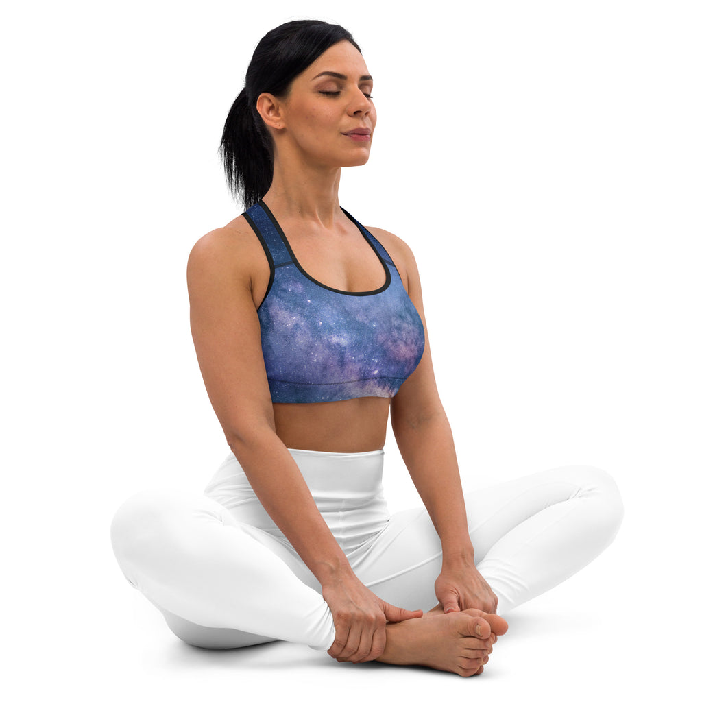 A blue and purple galaxy print women’s quick drying sports bra with black trim designed for active wear