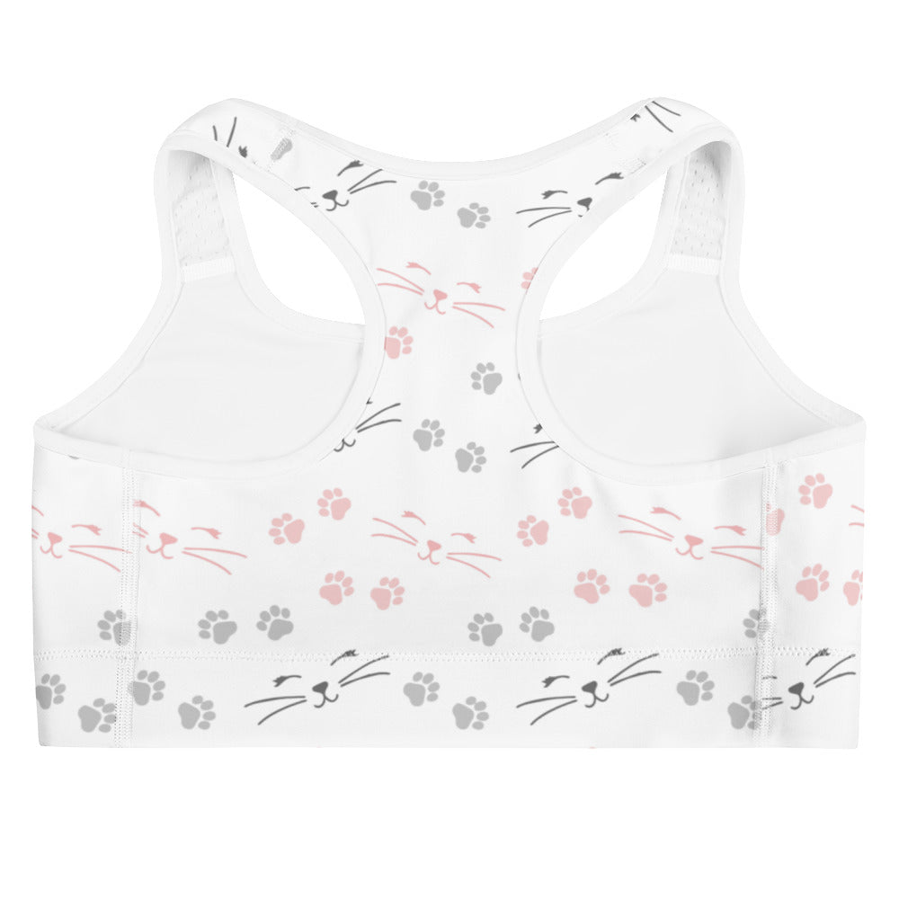 White quick drying women’s sports bra with pink and gray cat faces whiskers and paw prints pattern