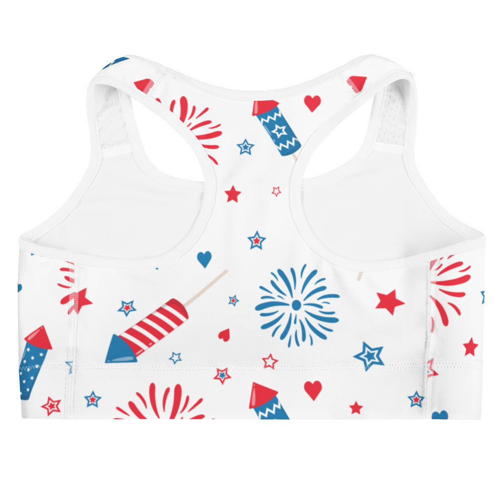 White quick drying women’s sports bra with red and blue fireworks stars and hearts playful pattern