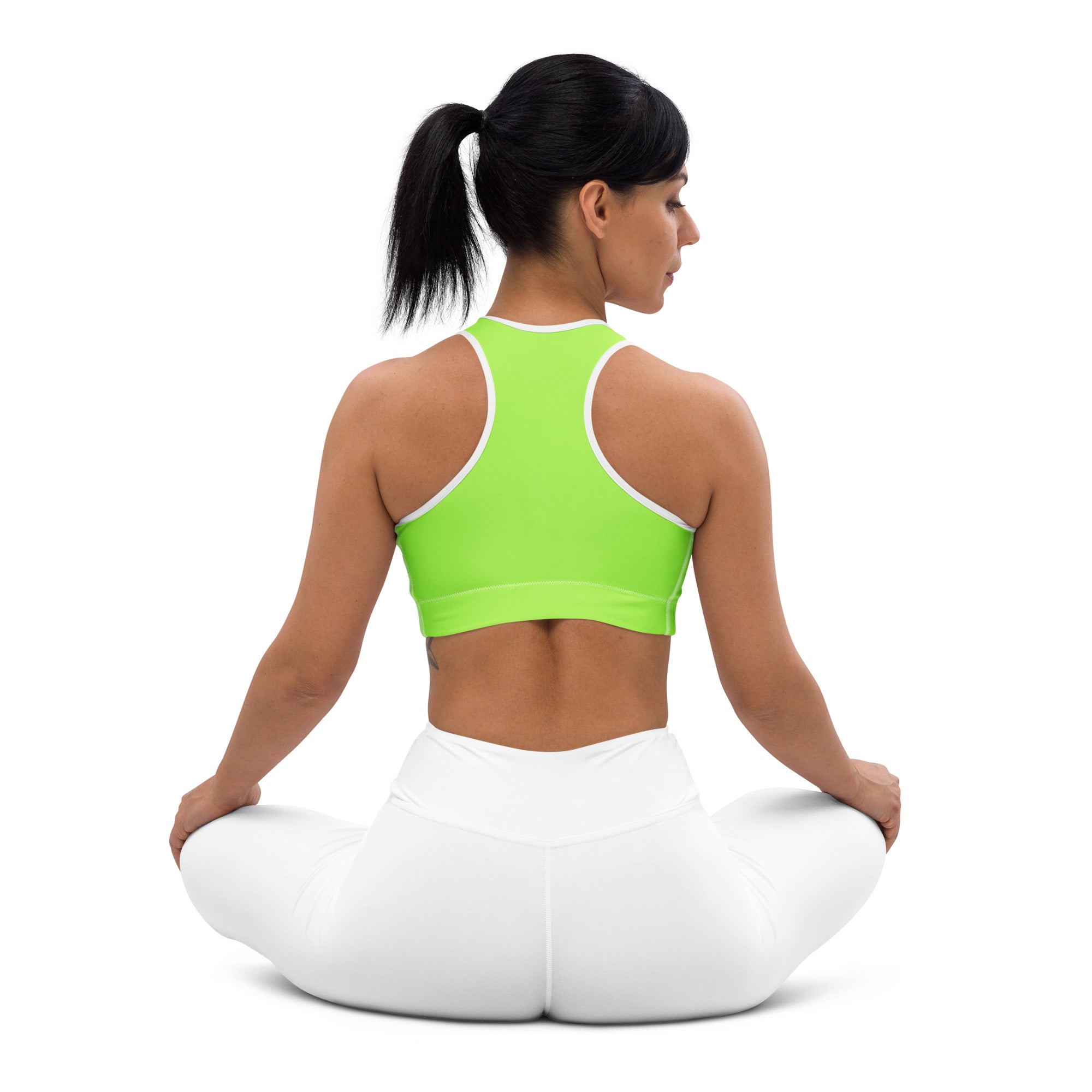 A vibrant lime green quick drying sports bra with white trim and racerback design for women