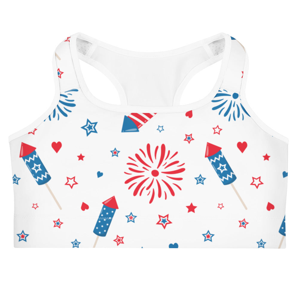 White quick drying women’s sports bra with festive red white and blue fireworks rockets stars and heart design
